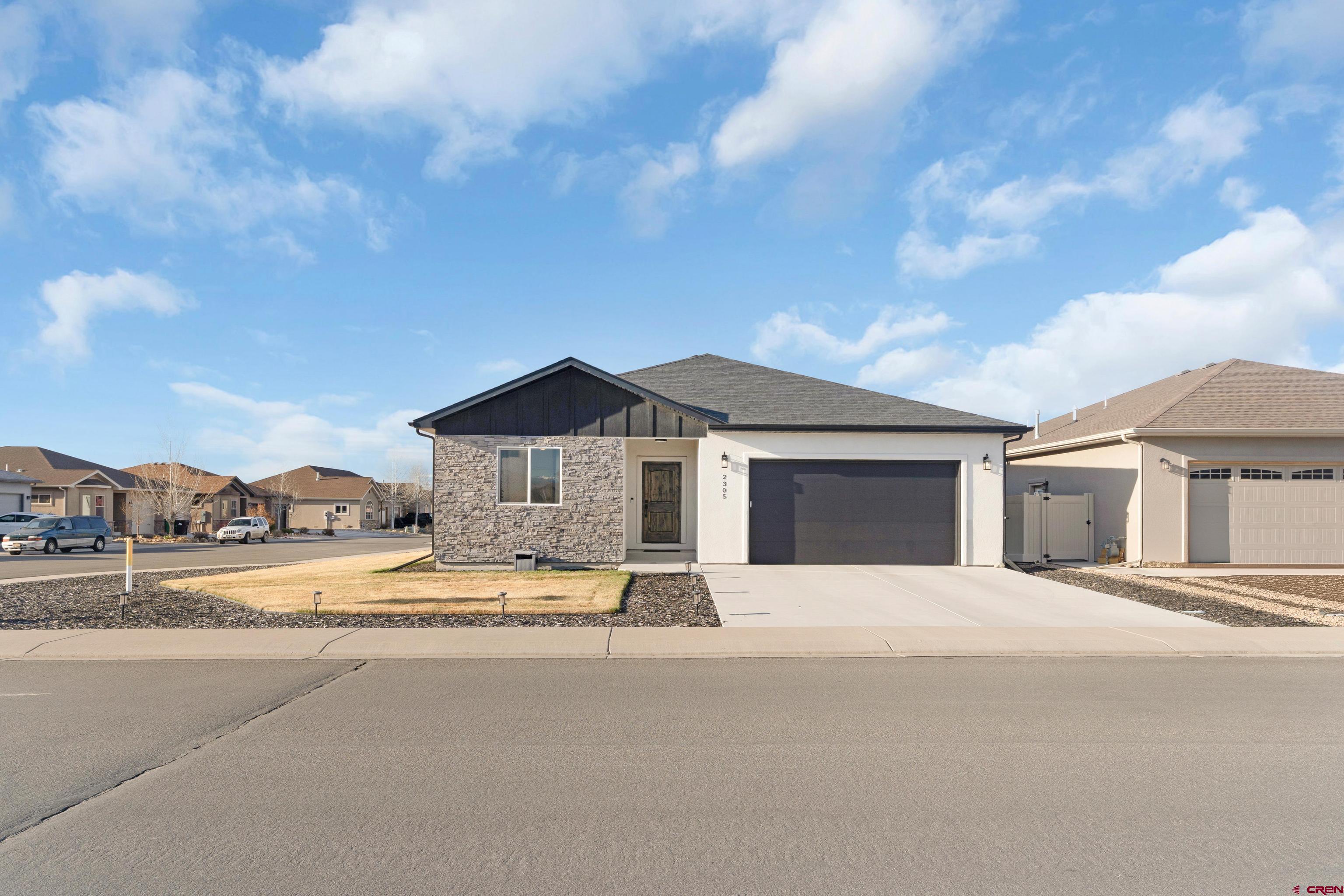 Welcome to 2305 Mountain Pines Drive, a beautifully maintained and nearly new home in Montrose. This stunning 3 bedroom, 2.5 bathroom home offers 1,690 sq ft of modern living space, built in 2020, and feels like brand new! Situated on a spacious lot with a beautifully manicured lawn and a charming back patio. Inside, you're greeted by a modern and inviting entryway leading to an open and airy floor plan with 9-foot ceilings throughout. The home boasts durable vinyl plank flooring, stylish tile, and cozy carpeting in the guest bedrooms. The spacious kitchen features sleek quartz countertops, stainless steel appliances, a beautiful backsplash, and a walk-in pantry for plenty of storage. The primary suite offers a walk-in closet, a linen closet, and a beautifully tiled shower and a double sink vanity. Two additional guest bedrooms are perfect for family or guests, complemented by a guest bathroom and a half bath for visitors. Located near the renowned Bridges Golf Course, the Montrose Recreation Center, as well as a variety of dining and shopping options, this home provides both convenience and comfort. Don’t miss the opportunity to make this house your dream home! With modern finishes, a fantastic location, and a well-maintained feel throughout, this property won’t last long.