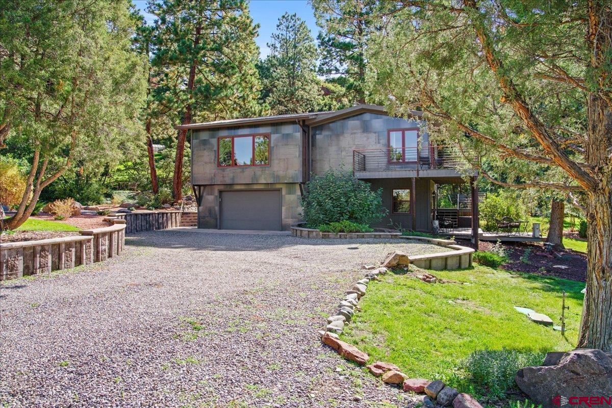 What is the definition of "Special"? The dictionary defines it as "Surpassing what is common or usual, exceptional or distinct among others of its kind". This home is the very definition of "Special". Located a few minutes from both Ridgway with its rich mining history and Ouray, a historic mining town, it affords you the opportunity to easily take advantage of everything the area has to offer not the least of which are hiking, biking, enjoying art galleries, live music and plays as well as fabulous restaurants. A quick hop onto Hwy. 550 takes you to Montrose for major shopping and Telluride with all its many activities and festivals in the summer and world class skiing in the winter. The terraced decks and patios allow for hours of enjoying the surrounding towering pines, magnificent red rock cliffs, spectacular mountain views and the changing seasonal colors: snow capped peaks in the winter, spring blooming forsythia and purple allium, the multicolored peonies in the summer, the red, yellow and oranges of the late summer daylillies in addition to the unequalled yellows and oranges of the aspens and oaks in the Fall. The home is a very open, spacious Mountain Modern masterpiece. The great room is unbelievably cozy surrounded in split cedar siding, wood beams and decking with the added charm from the wood burning stove nestled in the stone wall. The kitchen cabinets are set off by the stainless steel backsplash and appliances, granite counters and other remarkable accents. The kitchen sink overlooks the tranquil garden. The master suite is very large and features beautiful hardwood flooring, a walk thru dressing room with a double vanity, granite counter and plenty of closet space. The huge picture window affords a view of the garden and down the valley to Ridgway. An additional bedroom and bath set off by themselves provide lovely accommodations for family and friends who may just be more than comfortable and stay too long! Ditch water rights irrigate the lawns while beds are drip irrigated with Tri County water. The garage is listed as one car but is oversized. The home is being offered furnished including kitchenware but does not include the extensive art work. Unique lighting for art is in place, however. A turnkey situation that allows you to begin enjoying it immediately! This is an unequaled opportunity to retreat from the craziness of our world and spend quiet, restful time in a exquisitely beautiful setting. There are times when you simply have to experience first hand what such a special property has to offer. Come and take a look. You will not be disappointed.