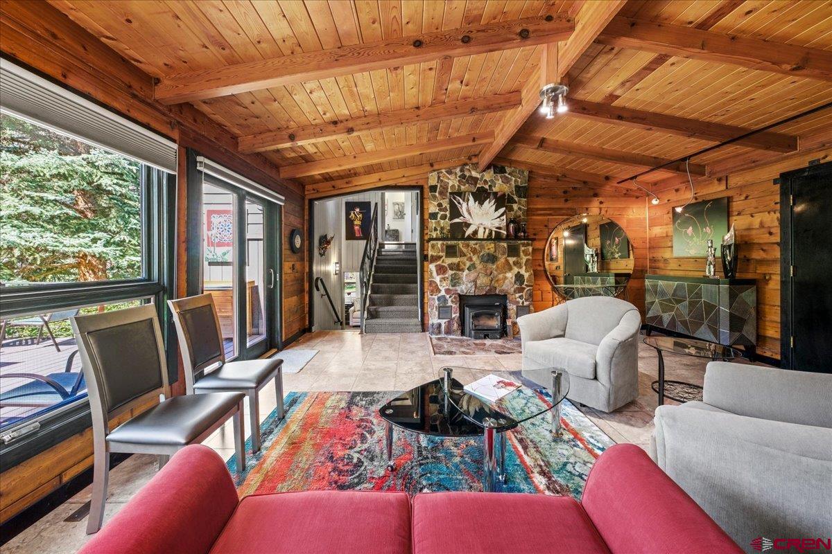 What is the definition of "Special"? The dictionary defines it as "Surpassing what is common or usual, exceptional or distinct among others of its kind". This home is the very definition of "Special". Located a few minutes from both Ridgway with its rich mining history and Ouray, a historic mining town, it affords you the opportunity to easily take advantage of everything the area has to offer not the least of which are hiking, biking, enjoying art galleries, live music and plays as well as fabulous restaurants. A quick hop onto Hwy. 550 takes you to Montrose for major shopping and Telluride with all its many activities and festivals in the summer and world class skiing in the winter. The terraced decks and patios allow for hours of enjoying the surrounding towering pines, magnificent red rock cliffs, spectacular mountain views and the changing seasonal colors: snow capped peaks in the winter, spring blooming forsythia and purple allium, the multicolored peonies in the summer, the red, yellow and oranges of the late summer daylillies in addition to the unequalled yellows and oranges of the aspens and oaks in the Fall. The home is a very open, spacious Mountain Modern masterpiece. The great room is unbelievably cozy surrounded in split cedar siding, wood beams and decking with the added charm from the wood burning stove nestled in the stone wall. The kitchen cabinets are set off by the stainless steel backsplash and appliances, granite counters and other remarkable accents. The kitchen sink overlooks the tranquil garden. The master suite is very large and features beautiful hardwood flooring, a walk thru dressing room with a double vanity, granite counter and plenty of closet space. The huge picture window affords a view of the garden and down the valley to Ridgway. An additional bedroom and bath set off by themselves provide lovely accommodations for family and friends who may just be more than comfortable and stay too long! Ditch water rights irrigate the lawns while beds are drip irrigated with Tri County water. The garage is listed as one car but is oversized. The home is being offered furnished including kitchenware but does not include the extensive art work. Unique lighting for art is in place, however. A turnkey situation that allows you to begin enjoying it immediately! This is an unequaled opportunity to retreat from the craziness of our world and spend quiet, restful time in a exquisitely beautiful setting. There are times when you simply have to experience first hand what such a special property has to offer. Come and take a look. You will not be disappointed.