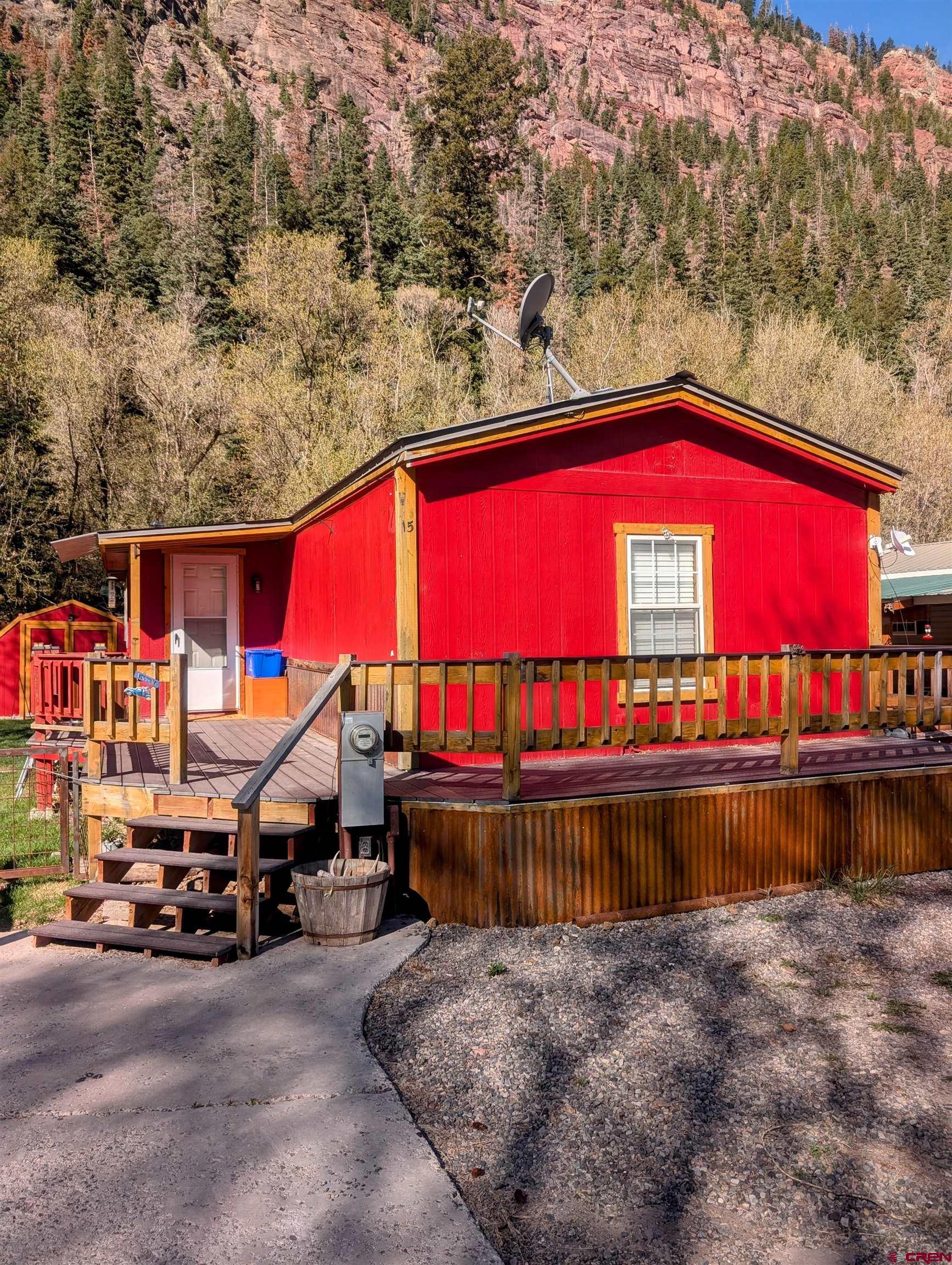 The real affordable living in Ouray is here.  This four bedroom, two full bath mobile home was built in 2001 with 1,280 square foot and is located just a little north of Ouray on Oak Street.  The owner has installed some new tile and good carpeting along with a custom built in entertainment center.  He also built a mudroom to take your shoes off when entering.  The appliances are very nice.  Some almost brand new.  The deck is large and has great views of the mountains. This place is in Swiss Village mobile home park which is currently under contract.  The residence of this park have band together to purchase the land their homes are on.  You will be a part of this organization.  When this closes the mobile home park is yours and your neighbors, collectively. There will be restrictions on the park and you must qualify a few different ways.  The park is owners occupy only, you can not rent your home out.  This is a really good opportunity to own your own home and live in beautiful Ouray, Colorado!!
