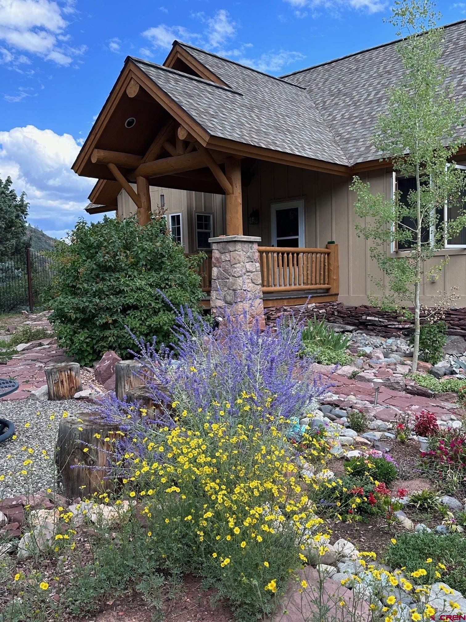This beautifully remodeled mountain retreat offers the perfect blend of luxury, adventure, and water access, located on a private 1-acre parcel between Ridgway and Ouray in the exclusive Black Lake community—just a short drive from Telluride. With nearly 100 acres of shared open space including a private lake, parks, trails, and direct access to public lands, this property is a dream for outdoor lovers who crave year-round recreation like hiking, biking, fishing, kayaking, and paddleboarding. Set just off scenic County Road 17—a favorite route for cyclists and hikers—the home is accessed through a gated entrance and a stained concrete drive that leads to a knoll-top setting with stunning 360-degree views of the surrounding mountains and valley. Inside, the home is thoughtfully designed for comfort and connection, featuring soaring cathedral ceilings, rustic log accents, a dramatic floor-to-ceiling stone fireplace, and a gourmet kitchen with custom cabinetry, granite countertops, and high-end appliances. Two main-level suites include spa-style bathrooms and private outdoor access, with one offering a vaulted glassed-in sitting room and wet bar—ideal as a master or luxury guest space. The lower level includes two additional bedrooms, a full bath, laundry, and a walk-out to the oversized two-car garage, while the spacious loft provides a flexible area for an office, playroom, or media space with access to a covered deck overlooking the forest and peaks. Four separate outdoor living areas allow you to enjoy the changing seasons in comfort and privacy. Ownership includes full access to the Black Lake estate and its extensive conservation easement, which keeps property taxes low and ensures protected beauty for generations. With modest annual dues covering professional maintenance of the lake and grounds, you’ll enjoy peace of mind along with unmatched natural amenities. Whether you’re skiing in Telluride, soaking in the Ouray Hot Springs, biking Ridgway’s scenic roads, or simply relaxing on your deck by the lake, this exceptional home places you in the heart of Colorado’s most iconic mountain lifestyle.