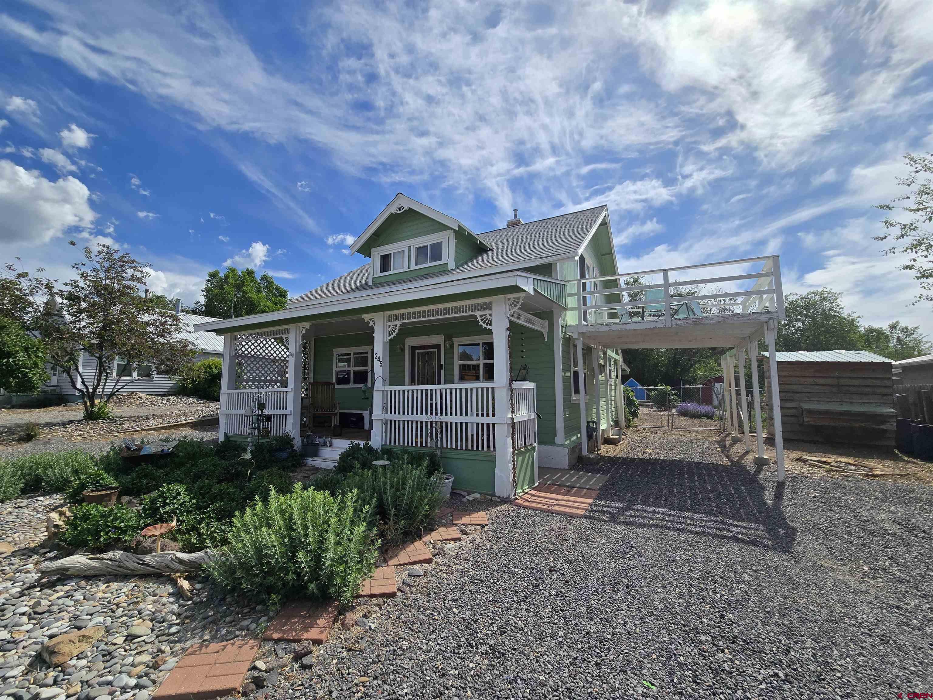 Charming 2-story home that feels like a farm in the country but is located right in town. From the ornate wood accents on the front of the house, to the perfect front porch for relaxing and wood floors, this home will give you that old-timey feeling yet with modern, neutral touches throughout. Three bedrooms and a bathroom upstairs and an option of a fourth bedroom or office on the main level along with another bathroom. There is a balcony off of one of the bedrooms upstairs, perfect for star-gazing and sunbathing. The two fireplaces are on the main level, one is wood and one is gas which is practically brand new. The kitchen has been redone in the past few years including new appliances and has beautiful cabinet walls with glass doors to showcase your favorite dishes and collectibles. Evaporative cooler to keep you comfortable through the few weeks in the summer when it's hot out. The electric panel has been updated. Recent coat of exterior paint. The parcel is .21 acres and has a spacious backyard with fire pits, garden beds and a chicken coop. Right around the corner from the main area of town for easy access to coffee shops, restaurants, parks, Grand Mesa Arts & Events Center, festivals and much more. Not only that but Grand Mesa is a hop, skip and jump away which is an outdoor year-round playground.