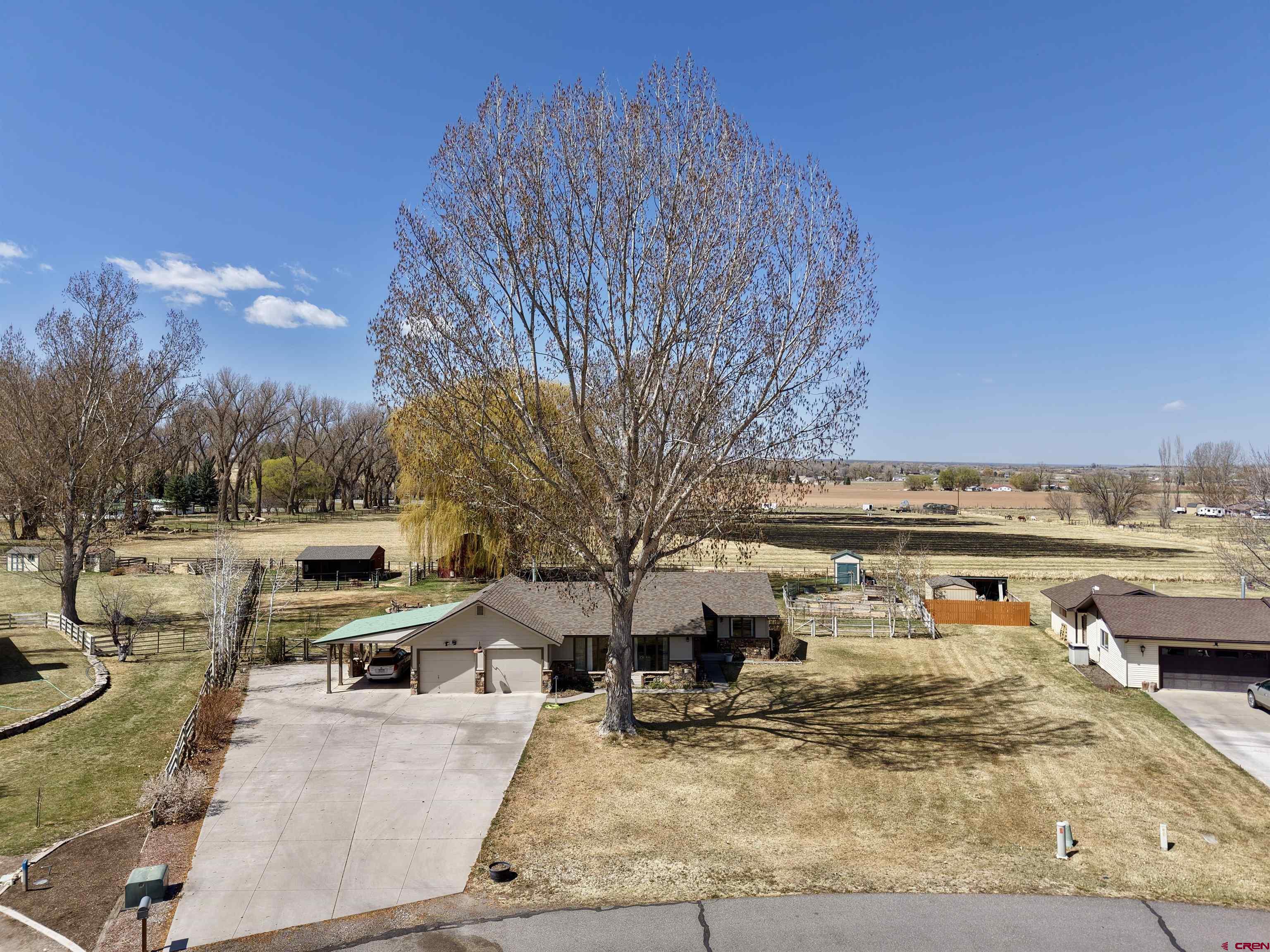Here is the chance you've been waiting for in the desirable Spring Creek area of Montrose...a beautiful 3-bedroom, 2-bathroom ranch-style home with just under an acre of irrigated land that's been cared for and manicured to suit a variety of needs. This property is situated just minutes from town in a quiet country culdesac and it truly contains all the things that make Spring Creek a highly sought-after area...massive mature trees in front and back, a spacious yard and lot maintained with irrigation water on an automatic sprinkler system, outbuildings to be used as you see fit, and an abundance of parking. Looking to garden or have some chickens and goats....no problem here, and it's already set up to do so. Turning to the inside, you'll find the sellers have truly gone above and beyond in updating and maintaining this beautiful home. The living room and den/family room on both sides of the kitchen and dining areas allow for an abundance of natural light that just makes this home inviting and comfortable. A great setup for gathering family and friends inside and out. The home is turnkey as the sellers have put in fresh paint, new stainless steel appliances, a new hot water heater, a new irrigation pump, new carpet in bedrooms, a new wood deck, 8 new fruit trees out back along with 2 pine trees. The list goes on, and the value is undeniable....call today for your private showing before it's gone!