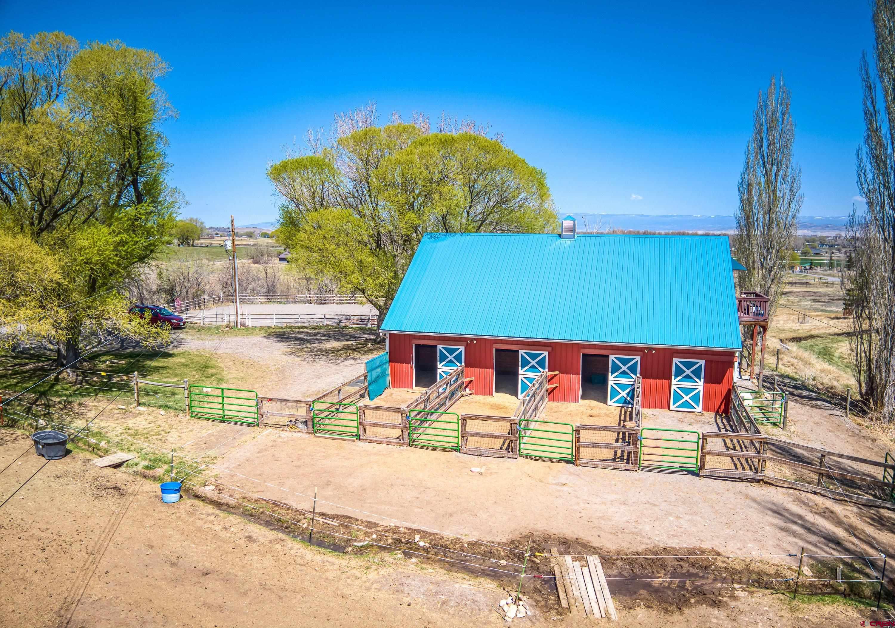 Imagine a horse property nestled on 5 irrigated acres of land, surrounded by lush greenery, garden spaces, scenic landscapes and even distant mountains on the horizon. Privacy here reigns supreme, with natural barriers like tall trees forming a cocoon of serenity around the estate.  The location is prime—accessible yet tucked away. It’s close enough to conveniences like local shops, schools, and equestrian trails, but far enough to feel secluded. The property features pastures for grazing, sturdy fences, and even a charming 48x36 barn with spacious stalls, a tack room, wash bay, hay storage and kitchen/break room. There is a finished bonus room above the barn for overnight quests or a helper's bunk. There is a regulation sized riding arena for training and practicing.  At the heart of the property, there’s a charming 2 story home with 2 car attached garage classic architectural details, open concept, vaulted ceiling and a loft overlooking the family room with a lovely fireplace. Large mudroom to kick off your boots and a greenhouse/sunroom for all your herbs and flowers. A walkout 1 bedroom, 1 bathroom apartment below with a kitchen, dining area and living room. Adjacent to the main home is a tiny house with a modern twist, perfect for guests, a private retreat, or a creative workspace.  This haven is designed to offer peace for both horse and human, where every sunrise over the fields feels like a gift. Does this vision match what you had in mind?