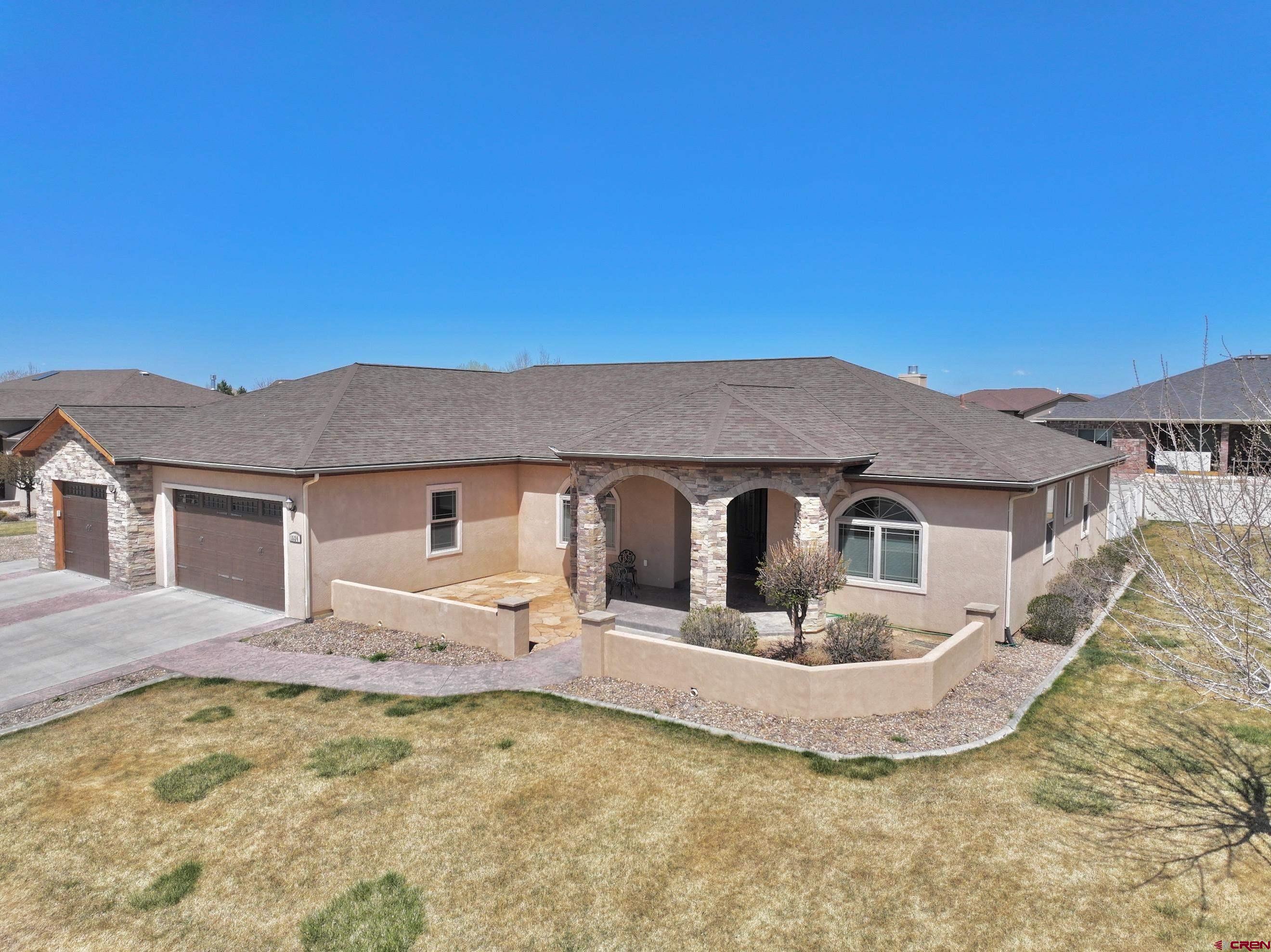 Experience luxurious single-level living in this beautifully appointed 3-bedroom, 3-bath residence, complete with a spacious office, nestled on a desirable corner lot in the tranquil Belle Haven Estates. Enjoy stunning mountain views and the peaceful ambiance of a quiet, established neighborhood.  From the moment you arrive, custom wrought iron front doors and a stoned, covered entry patio create a grand first impression. Step inside to a generous open-concept living area featuring beautiful knotty alder wood trim and doors, soaring ceilings, a cozy gas fireplace, teak wood floors, and seamless flow into the gourmet kitchen. Designed for both function and style, the kitchen showcases rich knotty alder cabinetry, granite countertops, stainless steel appliances, abundant counter space, a large walk-in pantry, a large bright skylight, breakfast nook, and direct access to a covered back patio and a fully fenced, private backyard oasis.  The thoughtful split floor plan offers ultimate privacy. Two spacious guest bedrooms share a well-appointed bathroom with double vanities and a tiled shower. The expansive primary suite is tucked away on the west wing of the home, boasting a luxurious ensuite bath with a jetted soaking tub, a large walk-in tiled shower, dual vanities, a huge walk-in closet, and an additional storage closet. A private door leads from the suite to an enclosed hot tub area, perfect for quiet relaxation.  The oversized office/craft room or formal dining room features large south-facing windows that fill the space with natural light.  Situated across from an open area, the home enjoys an added sense of privacy and serenity.  Home currently has fast Elevate internet.  The HOA provides irrigation water, keeping lawn watering costs low in the summer.
