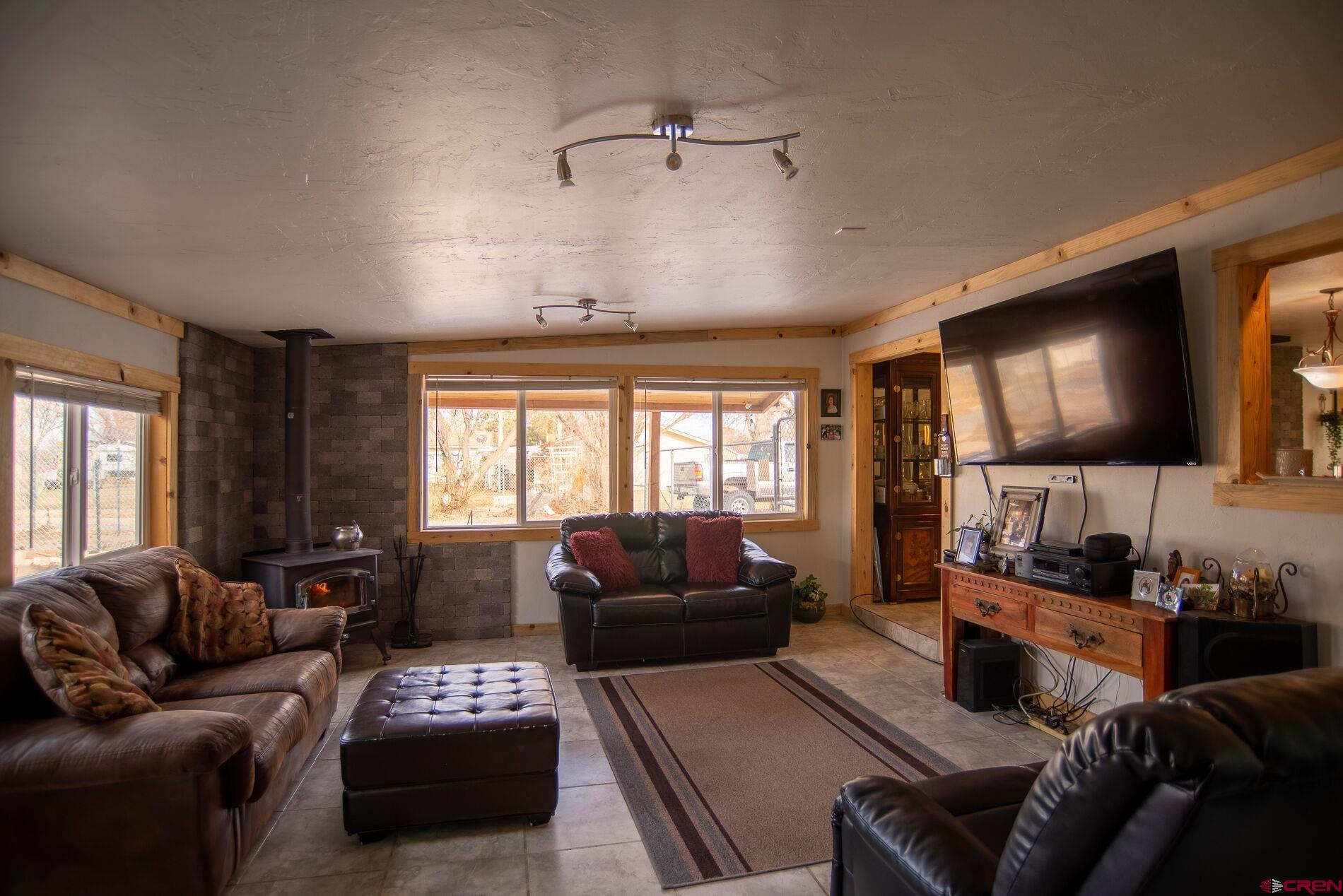 This home sits on .9 acres and features 4 bedrooms,  1 3/4 baths. 1680 sq ft. 2 wood stoves to keep the winter heat bills low. Exterior features Pizza oven, storage shed, work shed, large covered deck area perfect of large gatherings. Open shed for lawn mower and yard tool storage, small chicken coop, lots of mature trees, Large parking area and a Tree house that is just waiting for the new owners finishing touches.