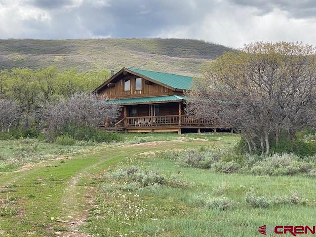 Serenity and Peace at 8150 feet. The old west is available to be yours with this charming true log cabin at Glade Ranch. Wake up in the morning to a crackling fire in the wood stove and look out over the high mountain meadows and watch the migrating Elk and Deer grazing in the tall meadow grasses. This humble oasis is solar and propane fueled with 3 bedrooms and a 3/4 bath. Step out on to the covered deck, dust off your pants, put on your hat and admire the scenery of the vast mountain peaks and vista's that are aww inspiring. Now it's time to decide, is the day gonna be filled by exploring on the side x side or saddling up the horses to do a little hunting. Maybe it'll be just a day of relaxing and unwinding from the world of fast pace and stress. I don't know lets just try and decide what's gonna be for dinner, get a little more coffee and let the day unfold. All the details of how the cabin works are in the listing. The most important thing is how well this log home fits in it's surroundings and the pace of life that it provides. Come take a drive with us and step back into the old west.
