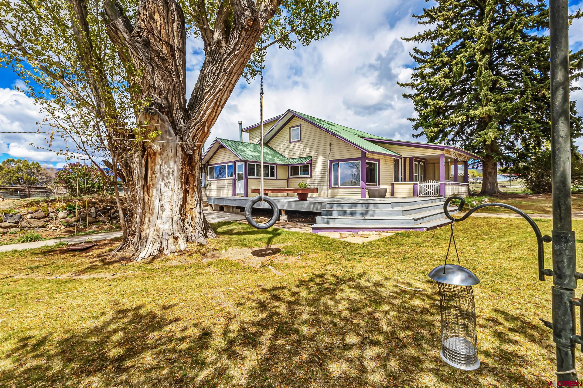 Quaint farmhouse on 3.81 acres with tremendous Grand Mesa views just outside of Cedaredge. This property is well equipped for a hobby farm with fenced pasture, some irrigation water, and several outbuildings. There is also an oversized 2 car garage/shop. Mature trees surround the home with an abundance of flowers, songbirds, and big views that set the country living tone. Large composite deck welcomes you into the home and a large brick paver patio sets you up for barbeques and entertaining while soaking in the Grand Mesa views. The home is 4 beds and 2 baths with over 2200 sq ft. of living space. Metal roof. No HOA or covenants.
