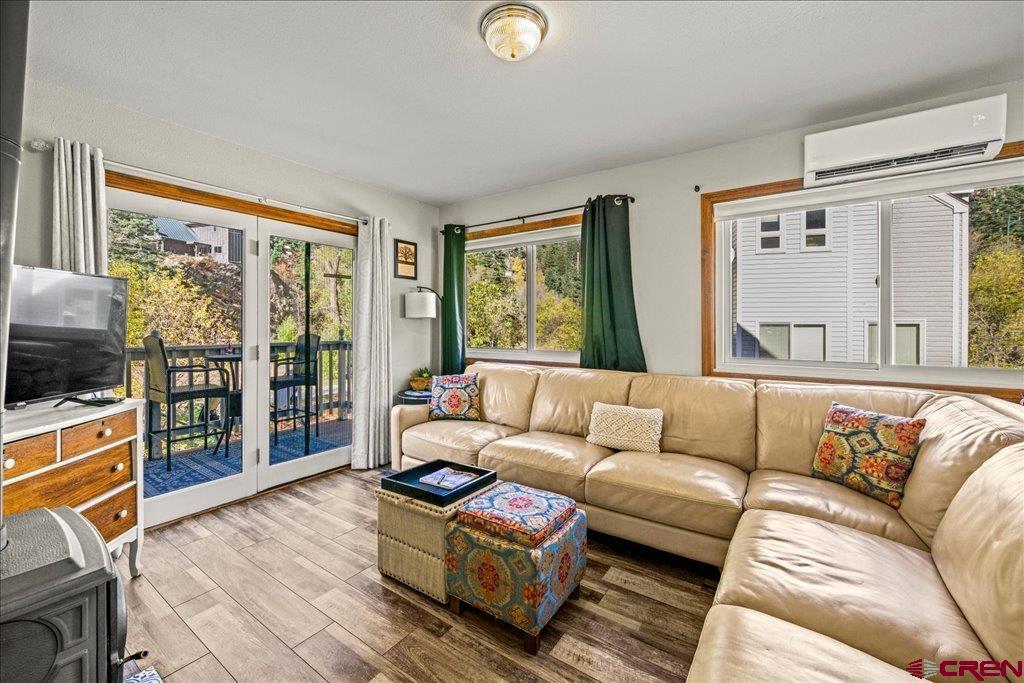Hard to find move-in ready, FULLY FURNISHED end-unit townhome on the Uncompahgre river in Ouray! Stylish 2BR/1.5BA, 1200 sq ft. fully remodeled with recent Boreal split system HVAC, windows, floors, & appliances. Private deck with mountain & river views. Wood stove, 1 car attached garage, and fast fiber WiFi. Super desirable location - just steps to the Hot Springs, Perimeter Trail & Downtown. Bright, cozy, stylish, & private. Includes ALL furnishings. Walk to hiking, dining, & year-round outdoor fun. Currently a licensed short-term rental with a very strong history. Ideal income property or private residence. This property has bookings through September that the owners will transfer to the new owner!