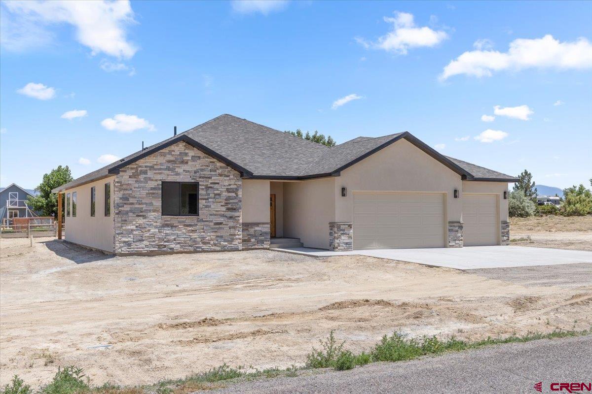 This beautifully crafted 1,958 sq. ft. home by Faucett Builders sits on a generous 1-acre corner lot with no HOA and breathtaking views—the perfect combination of privacy and freedom.  Inside, you’ll find a spacious open floor plan ideal for entertaining, with a large living room, dining area, and chef-inspired kitchen. The living room features a cozy gas fireplace with a stone surround, shiplap detail above, and a custom knotty alder pine mantel. Two TV mount locations provide flexible viewing options.  The kitchen is a showstopper, showcasing dual-toned maple cabinets with craftsman-style doors in an almond stain. Cabinet heights vary for visual interest and culminate in a full-size pantry. At the center is a 103-inch quartz island with sage colored cabinets featuring a farmhouse sink and built-in appliances—perfect for gatherings and culinary creativity.  Throughout the home, you'll enjoy pet-friendly luxury vinyl plank flooring, plush carpet in the bedrooms, and stylish tiled bathrooms. The split-bedroom layout offers a private retreat in the primary suite, complete with a walk-in closet, freestanding soaking tub, custom tiled shower with stone accents, and dual vanities.  Two additional bedrooms (approximately 12x11 ft), a second full bath, and a dedicated office or flex room with sliding barn door provide flexibility for family, guests, or work-from-home needs.  The oversized 3-car insulated garage includes extra space for a workshop and connects to a convenient laundry/utility room with a sink and built-in storage. The expansive lot provides room for RV parking, outbuildings, or toys, and is governed by light covenants—with no HOA restrictions.  Builder is in the process of providing landscaping to the front and side of the house.  This home is move-in ready and available for viewing—don’t miss your opportunity to own this one-of-a-kind property!