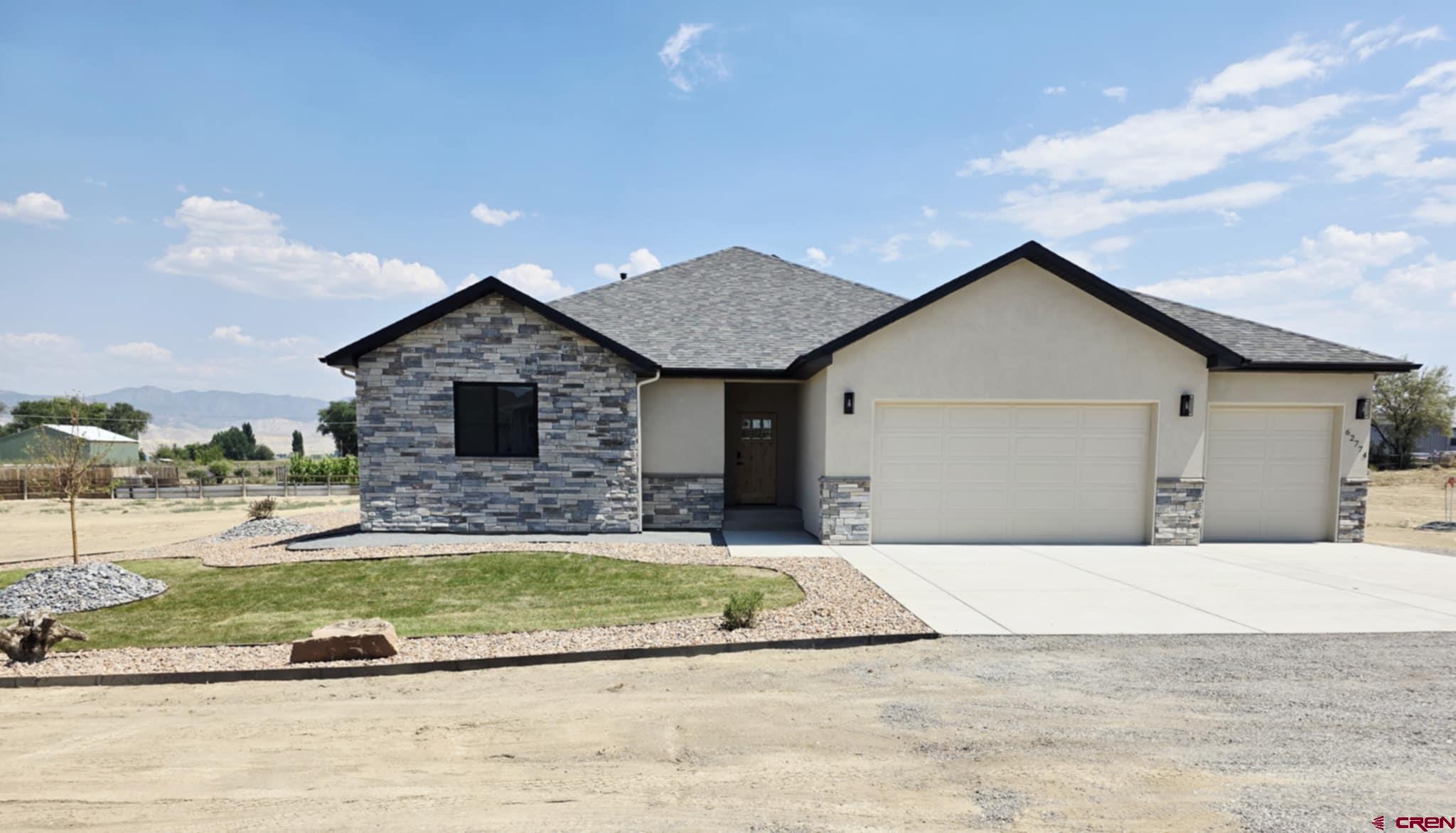 This beautifully crafted 1,958 sq. ft. home by Faucett Builders sits on a generous 1-acre corner lot with no HOA and breathtaking views—the perfect combination of privacy and freedom.  Inside, you’ll find a spacious open floor plan ideal for entertaining, with a large living room, dining area, and chef-inspired kitchen. The living room features a cozy gas fireplace with a stone surround, shiplap detail above, and a custom knotty alder pine mantel. Two TV mount locations provide flexible viewing options.  The kitchen is a showstopper, showcasing dual-toned maple cabinets with craftsman-style doors in an almond stain. Cabinet heights vary for visual interest and culminate in a full-size pantry. At the center is a 103-inch quartz island with sage colored cabinets featuring a farmhouse sink and built-in appliances—perfect for gatherings and culinary creativity.  Throughout the home, you'll enjoy pet-friendly luxury vinyl plank flooring, plush carpet in the bedrooms, and stylish tiled bathrooms. The split-bedroom layout offers a private retreat in the primary suite, complete with a walk-in closet, freestanding soaking tub, custom tiled shower with stone accents, and dual vanities.  Two additional bedrooms (approximately 12x11 ft), a second full bath, and a dedicated office or flex room with sliding barn door provide flexibility for family, guests, or work-from-home needs.  The oversized 3-car insulated garage includes extra space for a workshop and connects to a convenient laundry/utility room with a sink and built-in storage. The expansive lot provides room for RV parking, outbuildings, or toys, and is governed by light covenants—with no HOA restrictions.  Builder is in the process of providing landscaping to the front and side of the house.  This home is move-in ready and available for viewing—don’t miss your opportunity to own this one-of-a-kind property!