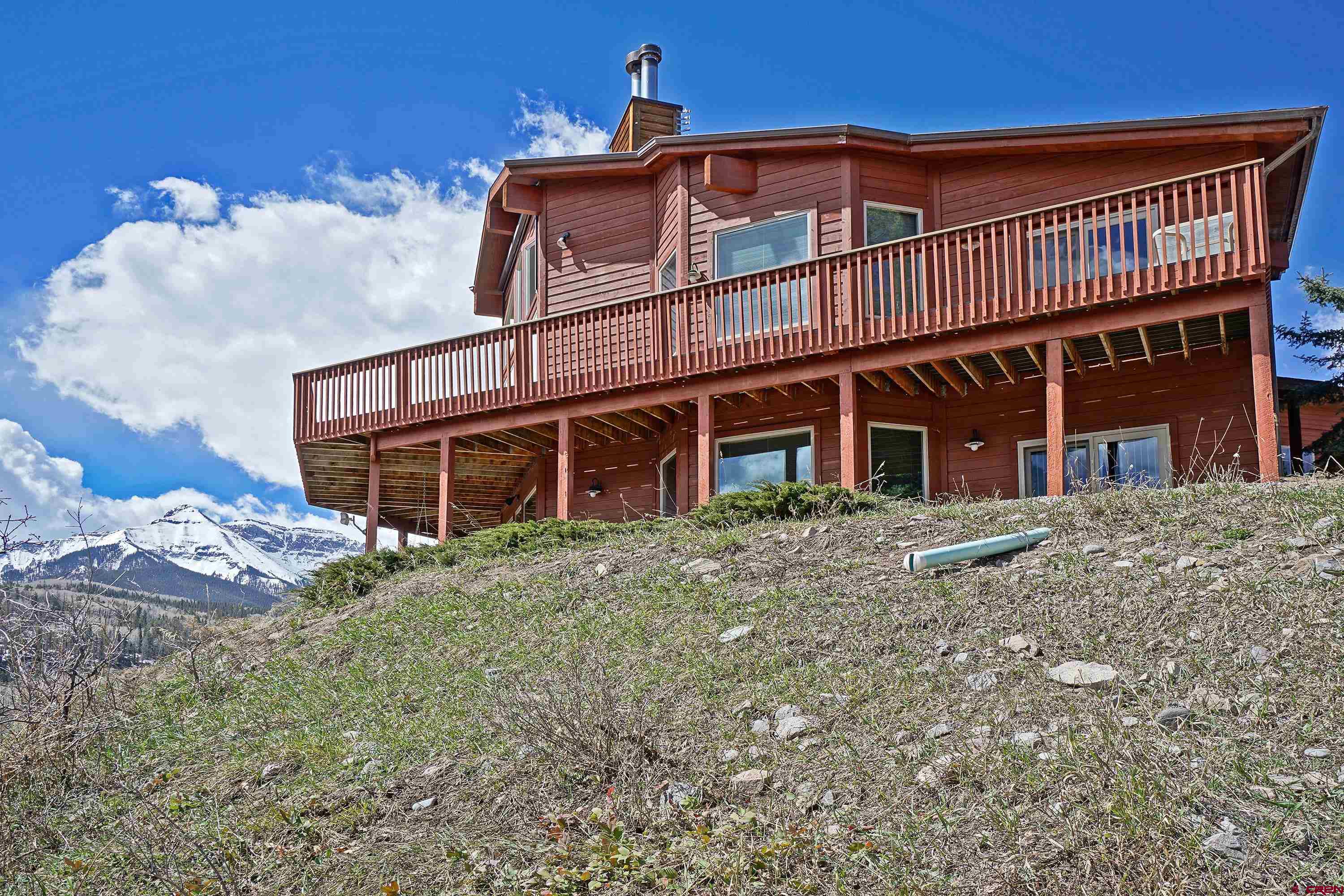 THIS HOME IS CURRENTLY UNDERGOING A DRAMATIC INTERIOR REMODEL WITH ALL NEW FLOORING, KITCHEN, PAINT, APPLIANCES, AND COMPLETE EXTERIOR STAINING AND IS SCHEDULED FOR COMPLETION ON JUNE 20, 2025.  INTERIOR PICTURES WILL BE AVAILABLE WHEN COMPLETED. Experience the ultimate mountain lifestyle with this luxurious 35-acre estate in prestigious Park Estates, ideally located between Ridgway, Ouray, and Telluride, Colorado. Set against the dramatic backdrop of the San Juan and Cimarron Mountains, this stunning home captures breathtaking, ever-changing views and offers unmatched access to year-round outdoor adventure—skiing, hiking, biking, and exploring the nearby National Forest.  Thoughtfully designed for comfort and entertaining, and undergoing a dramatic interior remodel with all new flooring, kitchen, paint and appliances, the home features spacious great rooms with a fireplace and wood burner, rich new Trex decks overlooking the mountains, and elegant en-suite bedrooms, including a spa-like steam bath. An oversized attached garage, plus a separate garage and toy barn, provide ample space for all your gear—perfect for embracing the Colorado lifestyle. Whether you're seeking a full-time mountain haven or a high-end vacation retreat, this property offers peace, privacy, and panoramic beauty in one of Southwest Colorado’s most desirable areas. An adjacent 35-acre horse-friendly parcel is also available, making this a rare opportunity for expansive living in a world-class mountain setting. Don’t miss your chance to own a legacy property near Ridgway, Ouray, and Telluride—where luxury, adventure, and nature meet. Schedule your private tour today and start your San Juan Mountain dream.
