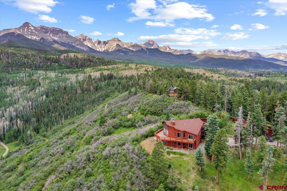 . "This property will be purchased by one who appreciates the splendor of the creation.  Enclosed pictures, taken from the property's deck, represent one of the most fabulous and inspiring view experiences one can have in the San Juan and Cimarron Mountains. The views are absolutely marvelous, spectacular and ever changing with the weather." -Randy and Linda Rich.  The words above are an invitation from the current owners to escape to an unparalleled mountain sanctuary, where luxury meets adventure in the heart of Southwest Colorado. This generously sized home on 35 acres offers an exclusive retreat, where you can immerse yourself in the beauty of nature and indulge in the ultimate mountain lifestyle.  Perfectly situated within the prestigious Park Estates, this home provides access to a year-round playground of outdoor pursuits. Whether you're seeking thrilling skiing adventures, tranquil hiking trails, or captivating photography opportunities, the nearby National Forest offers endless possibilities for exploration and relaxation and is an easy walk away. Designed to capture the essence of mountain living, every aspect of this home is crafted to maximize the breathtaking views of the surrounding San Juan and Cimarron Mountains. The exquisite great rooms are adorned with a fireplace upstairs and woodburner downstairs and offer direct access to  rich new Trex decks overlooking the San Juans.  There are luxurious bedrooms with elegant en-suite baths-one with steam.  Every detail of this mountain home exudes sophistication and comfort. The home has undergone a full remodel, with new flooring, counters and paint.  The kitchen now has quartz counters with undercounter lighting and beautiful stainless appliances.  The exterior was completely redone too, with new stain and Trex decking.    With ample space for entertaining and relaxation, this home invites you to bring your friends and embrace the true essence of mountain living.  An oversized attached garage and a separate garage and toy barn afford plenty of room for all the toys you'll want to have to fully enjoy this magical spot!  Plus, for those desiring even more room to roam, an adjacent 35-acre parcel with horse-friendly amenities is available exclusively for the new owners.  Don't miss the opportunity to make this grand Colorado property your own and become part of the legacy of San Juan Mountain living. Start planning your escape today and embark on a journey to luxury and adventure in one of the most spectacular settings in the world.