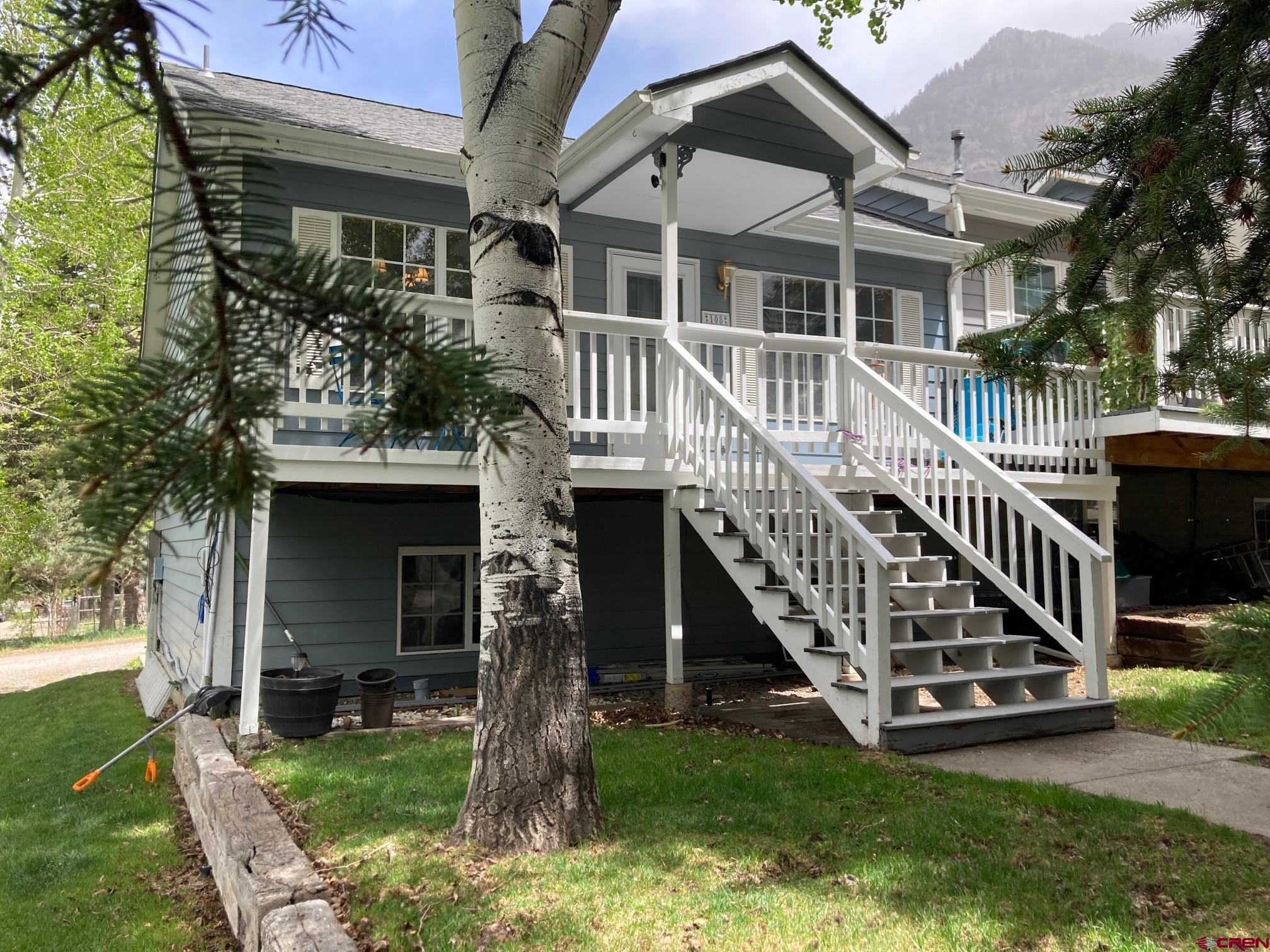Tucked just two blocks from the iconic Beaumont Hotel, this beautifully maintained 3-bedroom, 2-bath townhome places you right in the heart of everything Ouray has to offer—just minutes from epic hiking trails, thrilling jeep roads, world-class skiing, and endless mountain adventures in Ouray, Ridgway, Silverton, and Telluride. Designed with smart mountain living in mind, the open-concept upper level features a sun-soaked living, dining, and kitchen area, thanks to its southern exposure and abundance of windows. The main bedroom and a full bath are also located upstairs, with a Trex deck that delivers jaw-dropping views of the Amphitheatre, Twin Peaks, and the Rock of Ages—perfect for unwinding after a day on the trails or slopes. Downstairs, you'll find two additional bedrooms, a full bath, and a versatile bonus space ideal for a home office, second living area, or even a kitchenette. With zoning that allows for 30+ day rentals, the lower level could easily function as a lock-off unit—great for guests or investment potential. A single-car garage with opener, ample storage, and off-street parking add to the convenience, while low HOA dues cover yard maintenance, giving you more time to explore the rugged San Juans. Recent upgrades like luxury vinyl plank flooring and a new roof ensure move-in-ready peace of mind. Best of all, you’re walking distance from the Ouray Ice Park, Hot Springs, Ouray School, grocery stores, restaurants like the Outlaw, and more—making it easy to live like a true Ouray local. Whether you're seeking a full-time home, mountain getaway, or income property, this townhome is your launchpad for high-alpine adventure.