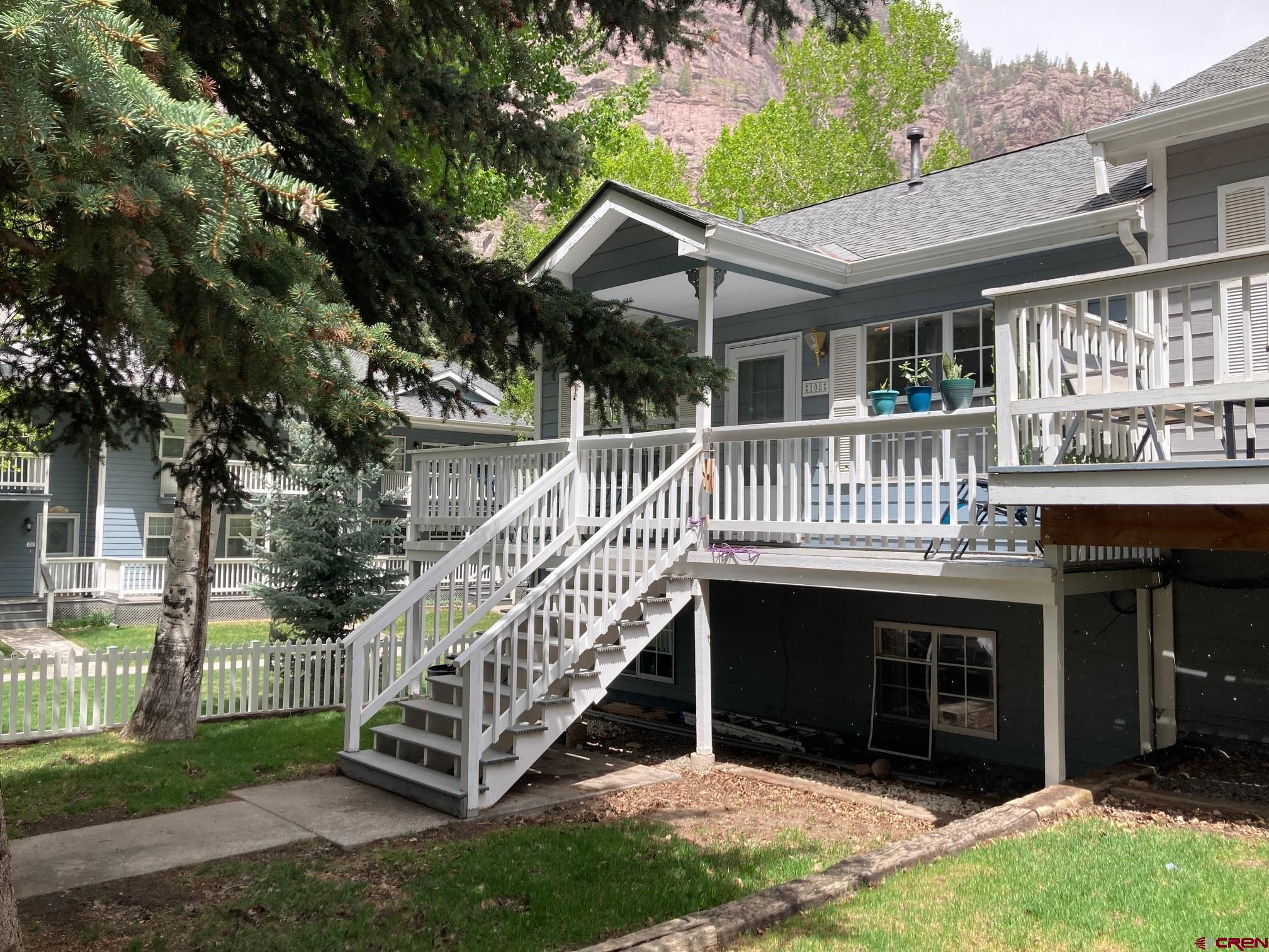 Tucked just two blocks from the iconic Beaumont Hotel, this beautifully maintained 3-bedroom, 2-bath townhome places you right in the heart of everything Ouray has to offer—just minutes from epic hiking trails, thrilling jeep roads, world-class skiing, and endless mountain adventures in Ouray, Ridgway, Silverton, and Telluride. Designed with smart mountain living in mind, the open-concept upper level features a sun-soaked living, dining, and kitchen area, thanks to its southern exposure and abundance of windows. The main bedroom and a full bath are also located upstairs, with a Trex deck that delivers jaw-dropping views of the Amphitheatre, Twin Peaks, and the Rock of Ages—perfect for unwinding after a day on the trails or slopes. Downstairs, you'll find two additional bedrooms, a full bath, and a versatile bonus space ideal for a home office, second living area, or even a kitchenette. With zoning that allows for 30+ day rentals, the lower level could easily function as a lock-off unit—great for guests or investment potential. A single-car garage with opener, ample storage, and off-street parking add to the convenience, while low HOA dues cover yard maintenance, giving you more time to explore the rugged San Juans. Recent upgrades like luxury vinyl plank flooring and a new roof ensure move-in-ready peace of mind. Best of all, you’re walking distance from the Ouray Ice Park, Hot Springs, Ouray School, grocery stores, restaurants like the Outlaw, and more—making it easy to live like a true Ouray local. Whether you're seeking a full-time home, mountain getaway, or income property, this townhome is your launchpad for high-alpine adventure.