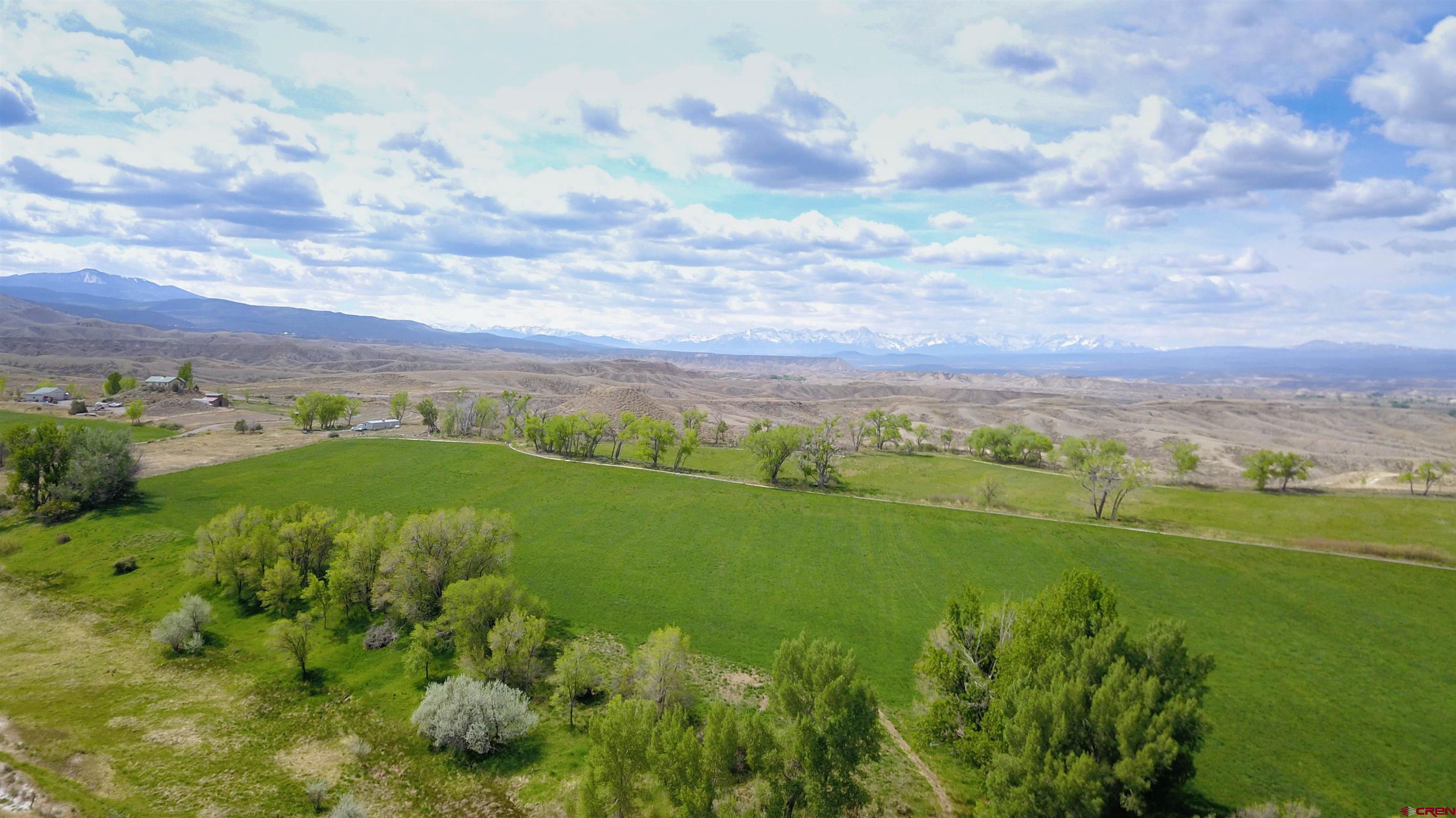 Incredible opportunity on 85± acres at Tract 3 of Circle H Ranch. This versatile property includes 45 acres of fully irrigated hay ground, ideal for livestock, equestrian use, or hobby farming. A charming historic farmhouse is nestled among old-growth fruit trees, adding character and potential for restoration, guest use, or rental income.  With city sewer available, water taps available, and utilities to the lot line, the property is well-positioned for development or estate construction. Investors may explore subdivision options for large homesites with expansive views.  Whether you're seeking a productive ag parcel, a homesite with stunning scenery, or a long-term development play, this land delivers exceptional value and flexibility.