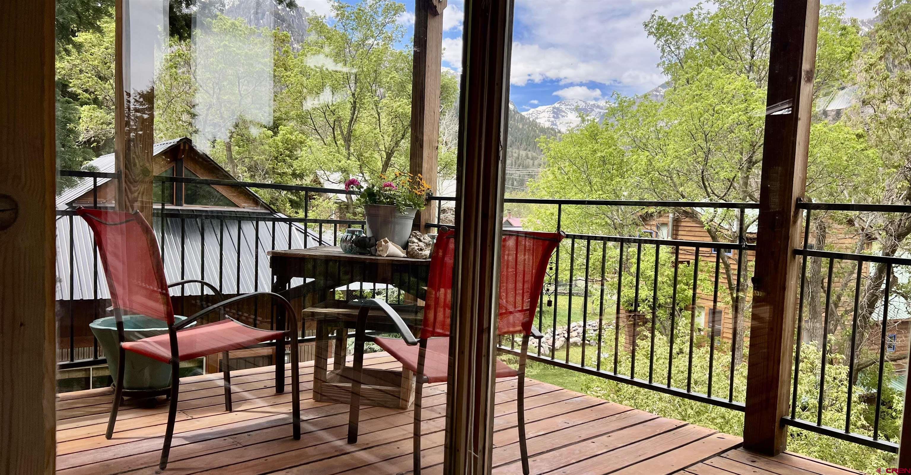 ARTISAN MOUNTAIN HOME. WALK OUT THE DOOR TO SHOPS, RESTAURANTS, HOT SPRINGS AND HIKING TRAILS. Private compound in a sunny location with income potential located in the town of Ouray. The main house has a comfortable wraparound deck.  The large living room with floor-to ceiling windows and vaulted ceilings is accented by a gas stove. Part of the main space has an office as well as the dining area and kitchen. The sizeable upstairs bedroom has a large bathroom with soaking tub/shower.  There is a separate guest area with a day bed that would make a nice office or workout area. The semi-finished basement has washer and dryer and lots of space to add additional storage or a bathroom and bedroom. The ADU/cottage is cozy, with living room, kitchen, bedroom, bath and deck, perfect for rental or hosting family and friends. Both the main house and the ADU have fiber optic internet, making the spaces ideal for working from home. Detached one-car garage. Indicated square footage is both residences combined. Take in the rugged beauty of Ouray while enjoying privacy and tranquility in a unique space.
