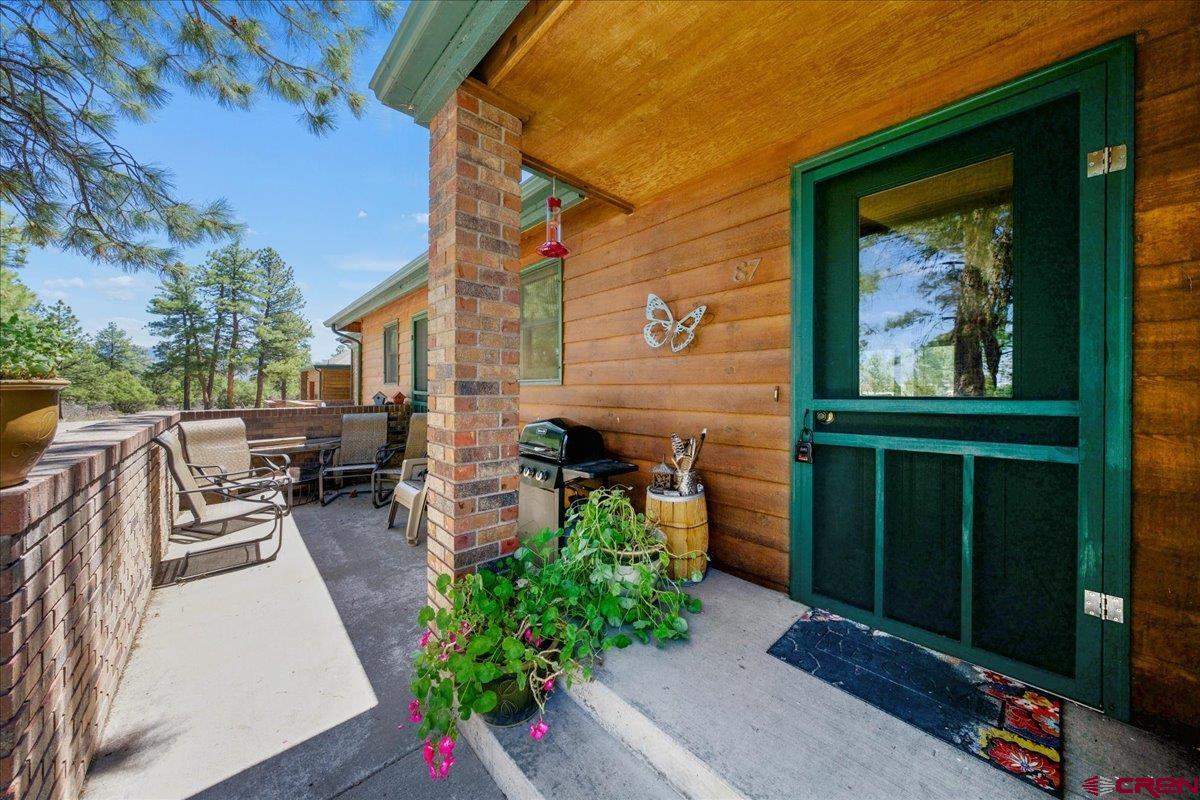 This lovely townhome offers beautiful views in a peaceful setting, surrounded by mature Ponderosa pines. Inside, you'll find a beautifully remodeled kitchen featuring gorgeous cabinetry, granite countertops, and a tastefully tiled backsplash. The cozy fireplace, inset with a pellet stove, adds ambiance and warmth to the living space—and also serves as a low-cost heat source for the entire home.  New energy-efficient living room windows provide wonderful views of the open green space and surrounding mountains. Additional updates include stylishly tiled bathrooms with granite countertops, high-end carpet in the bedrooms, and more.  The attached single-car garage includes a fully finished bonus room—perfect for a home office, game room, workout space, or extra storage.  While this home has many outstanding features, its location is truly one of the highlights. The functional and accessible rooftop deck is one of three inviting outdoor spaces where you can relax and enjoy nature.  This is a small, five-unit complex, and homes here rarely come on the market. Don't miss this opportunity—call Wild West Realty today to schedule your showing!