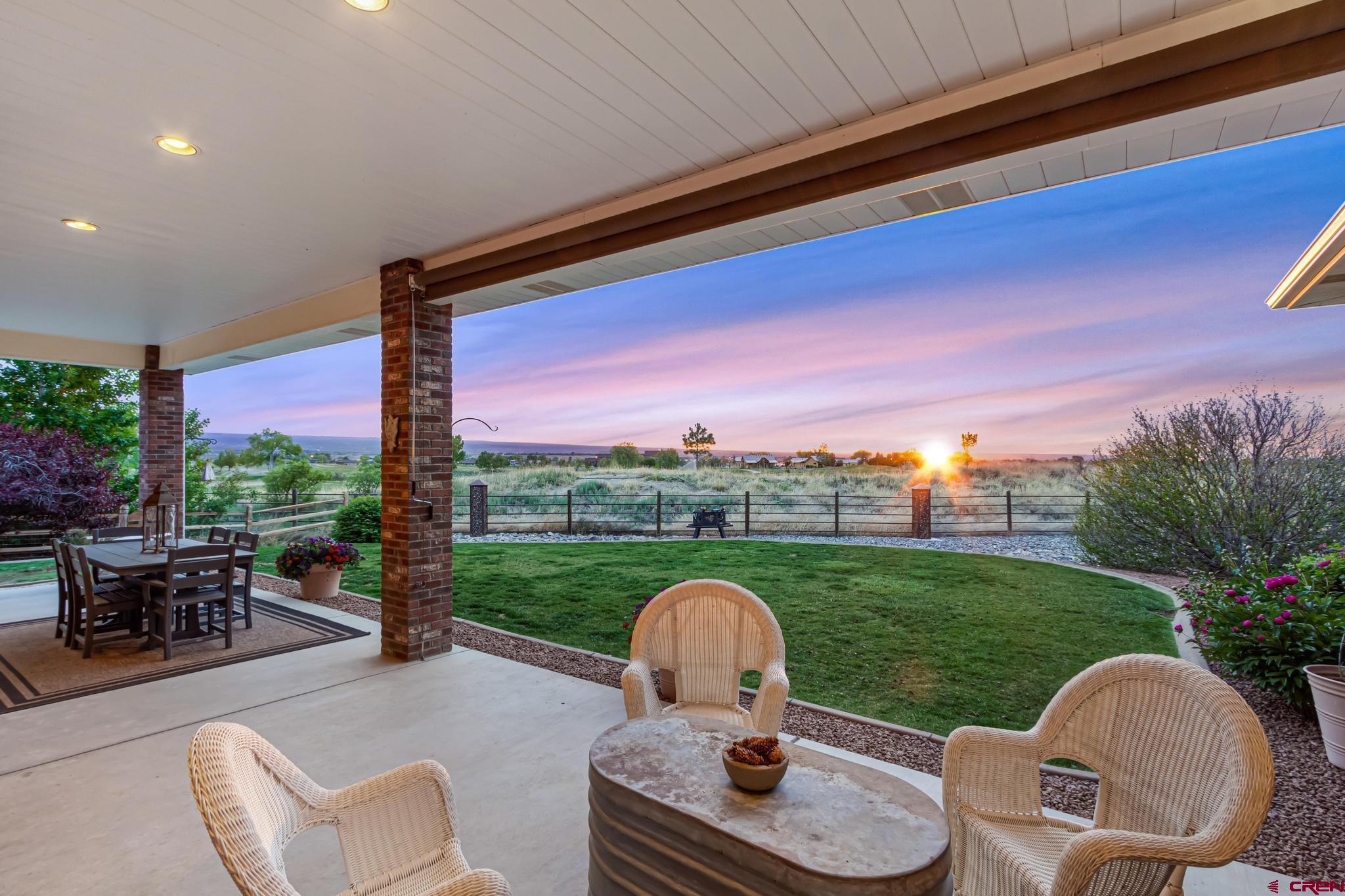 Welcome to 2809 Lost Creek Road N in Montrose, Colorado — a beautifully maintained, semi-custom red brick home located in The Preserve, backing to the 6th hole of The Bridges Golf Course. The fully xeriscaped front yard offers low-maintenance beauty with views of the San Juan Mountains. This 5-bedroom, 3-bathroom residence offers a spacious and functional layout with 9-foot ceilings, elegant hardwood flooring, carpeted bedrooms, and ceramic tile accents throughout. The home features a bright, open-concept living area and kitchen, complete with hickory cabinetry, custom hardware, pull-out drawers, granite countertops, tile backsplash, and an 18" skylight that enhances the natural light. The large primary suite includes a walk-in closet and a luxurious en suite bathroom with heated floors, a Roman tub, double sinks, and a tiled walk-in shower. Three additional guest bedrooms provide ample space and storage. A newly added guest suite features a kitchenette, full bathroom, separate heating, and private entrances from the side yard and garage, ideal for guests or extended family. The private backyard is designed for entertaining, featuring a covered patio with retractable shades, a gas hookup for grilling, and sweeping views of the Grand Mesa and The Bridges golf course. A brand-new fence encloses a grassy area with mature trees and a Additional features include a heated 2-car garage with 12-foot ceilings and attic, new 12x16 shed for additional storage, a large driveway with RV parking, complete with 50-amp electrical hookup, water, and dump station. This is only the second owner of the home, and it has been meticulously maintained and is move-in ready. Experience peaceful living, quality craftsmanship, and modern amenities all in one exceptional property on the south side of Montrose.