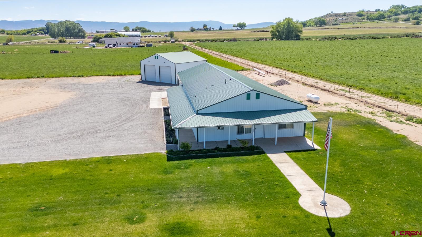 Versatile Barndominium in Coal Creek Valley — Equestrian Potential & Endless Space  Welcome to your dream setup in the heart of Colorado’s beautiful Coal Creek Valley, in Montrose, CO. This unique barndominium offers over 2,000 sq ft of heated space and the flexibility to create a truly customized home. Whether you're after a spacious primary suite, an expanded living area, or the ultimate craft or hobby studio, this floorplan is ready to adapt.  The main living space includes two bedrooms, a 3/4 bathroom, kitchen, dining area, and a convenient laundry center. Three large additional rooms—two of which have some cabinetry and sinks (one includes a half bath)—make ideal spaces for guest suites, home offices, or creative workspaces.  For vehicle or equipment storage, the oversized attached garage easily fits 5–6 cars or projects. A detached garage handles up to four vehicles or a large RV, trailer, or toy hauler.  Equestrian-Ready: This property once produced certified hay and has the acreage, layout, and access to become a premier horse property. Add a barn, riding arena, or paddocks and take full advantage of nearby public lands and miles of riding trails just minutes away. Water access, flat usable land, and existing infrastructure make this a rare find for equestrian enthusiasts.  Location:  A short distance to Montrose Regional Airport, dining, medical, and shopping. Golf courses, fishing and skiing are all a short distance.