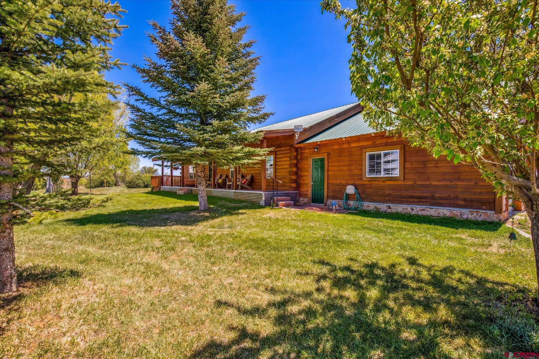 Incredible LaPlata Mountain Range Views from this Log Home in rural Mancos. Nicely situated at the top of a private road with only 3 other homes sharing the road. This fantastic 3.51 acre parcel comes with 1 share of Summit irrigation water out of the Turkey Creek ditch that flows across the upper portion of the property giving the effect of having live water views when it runs. This well maintained 1,536 sf, 3 bed 2 bath home has an extra large attached 2-Car garage along with a wonderful 864 sf barn with electrical  power and a concrete floor. The property is all set up for horses complete with a fenced corral, stalls and built in hay storage. One of the really nice features of this property is the fact that the electrical power comes in from the street to the barn and then is run under ground to the home so there are no unsightly power poles to impede the amazing views. This home sets up very well for entertaining on the large east facing deck or spend leisurely evenings nestled on the covered front porch. The master bedroom has an attached 3/4 bath and bedroom 2 is a nice size with bedroom 3 being the loft up above the living room. The utility room is also a good size and contains the washer and dryer closet along with a fourth bed or could make a wonderful office area. All the ceilings are vaulted and the great room has a woodstove keeping the entire home nice and toasty on chilly evenings and there's no need for central cooling because there's an ever present cool mountain air that cools things off on those warm summer nights. This home emits the true Colorado living experience nicely located just minutes from Mancos and Dolores and a short jaunt to Durango and Cortez. McPhee Reservoir is just down the road and Telluride just an hour away along with all of the other incredible sights and sounds of Southwest Colorado.