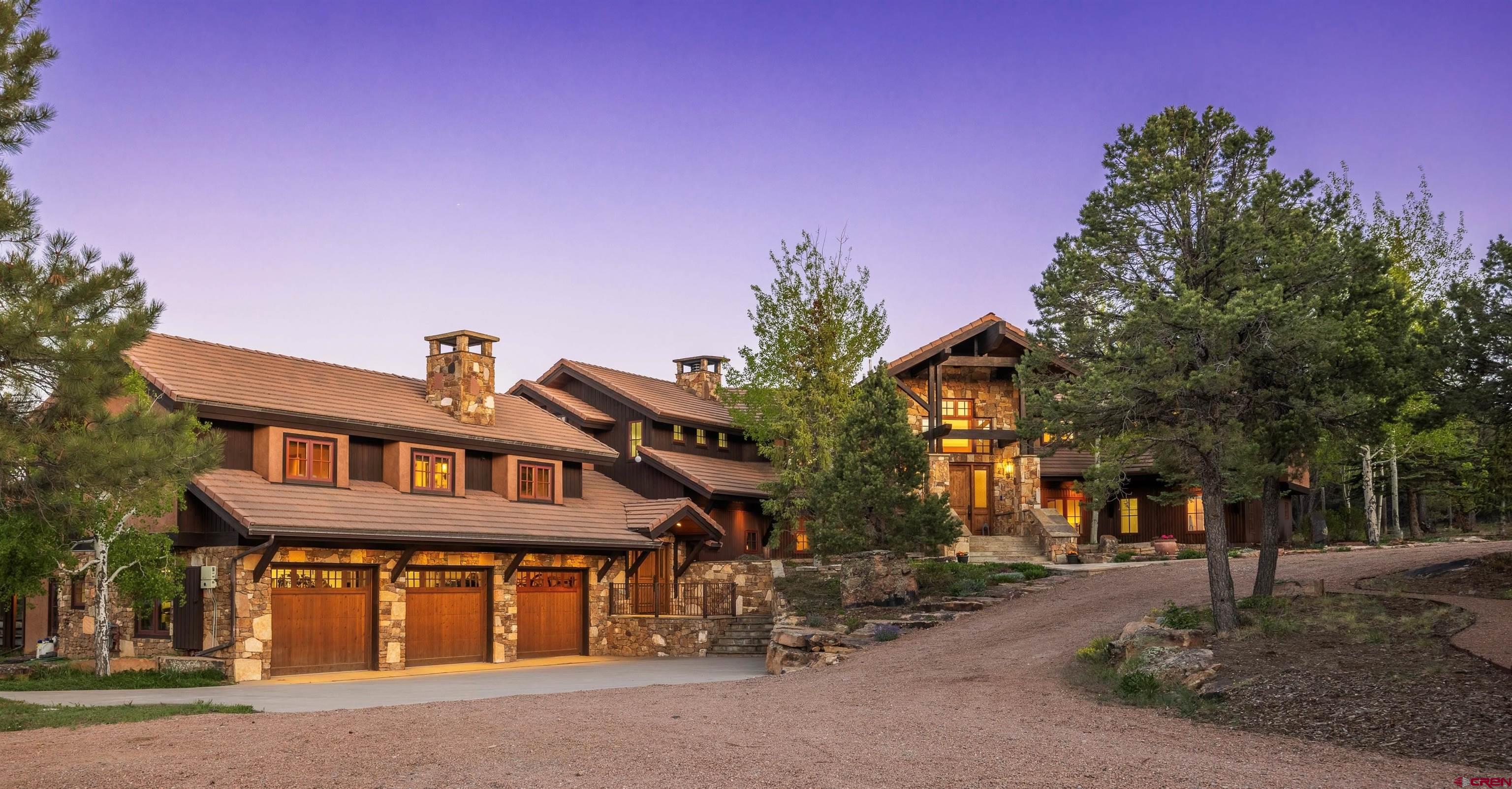 A Fully Remodeled Modern Mountain Estate on 5.78+ Private Acres. This exceptional multi-generational home underwent a complete transformation in 2025, elevated into a modern, mountain luxury home—offering timeless elegance and contemporary comfort throughout with the perfect balance between entertaining spaces, everyday living, and grandeur. Located at the end of a quiet cul-de-sac, this home offers panoramic views of both the San Juan and Cimarron Mountain Ranges, with the privacy and serenity of 5.78+ acres. Originally designed by famed architect Lee Anne Schmidt, the main home features 4 bedrooms and 3.5 baths, while the attached guest quarters offer 2 additional bedrooms and 2 bathrooms, complete with their own private entrance and a real wood-burning fireplace. Every aspect of the home was updated in 2025—from finishes to systems—to provide a fresh, modern aesthetic while preserving its architectural integrity. Inside, the kitchen was completely updated, and a walk-in pantry was added along with all new Wolf and Sub-Zero appliances and a massive functional island! Over 6.5 tons of HVAC capacity was added with the installation of mini-splits throughout. The main level includes the expansive kitchen with multiple dining options, primary suite(updated), guest bath(updated), and several large decks (including one with an outdoor shower), all re-stained. Splendid views are captured from nearly every window. The primary suite boasts 2 large walk-in closets, an updated bathroom with modern shower controls, a new modern fireplace, and a private deck reinforced and wired for an additional hot tub. The lower level offers a luxury game room, a stylish bar, and a media room(updated), along with several guest bedrooms(updated) and an additional laundry area. The guest quarters were also remodeled and self-contained, and can serve as a lock-off residence. One suite features a rainfall shower and bathtub; the other includes a walk-in shower. The attached 3-car garage includes an exercise room and easy-to-clean vortex spray liner flooring. Outdoor amenities include a 6-person hot tub, multiple decks and patios, entertainment areas, and a large greenhouse for year-round gardening or flex space. A low-maintenance concrete tile roof and an 18KW grid-tied solar system offer both style and sustainability. Fire mitigation work was completed along the fence around the home in addition to the entire 5-plus-acre lot. The security system has been augmented with state-of-the-art cameras, gate controllers, and connection points offering tremendous peace of mind. with your dream home secured, additionally be a large gate and high fence. This "end-of-the-road" sanctuary offers the rare combination of complete privacy and accessibility. Why build new when you can own a fully modernized masterpiece ready for immediate enjoyment? This is one home you need to see!