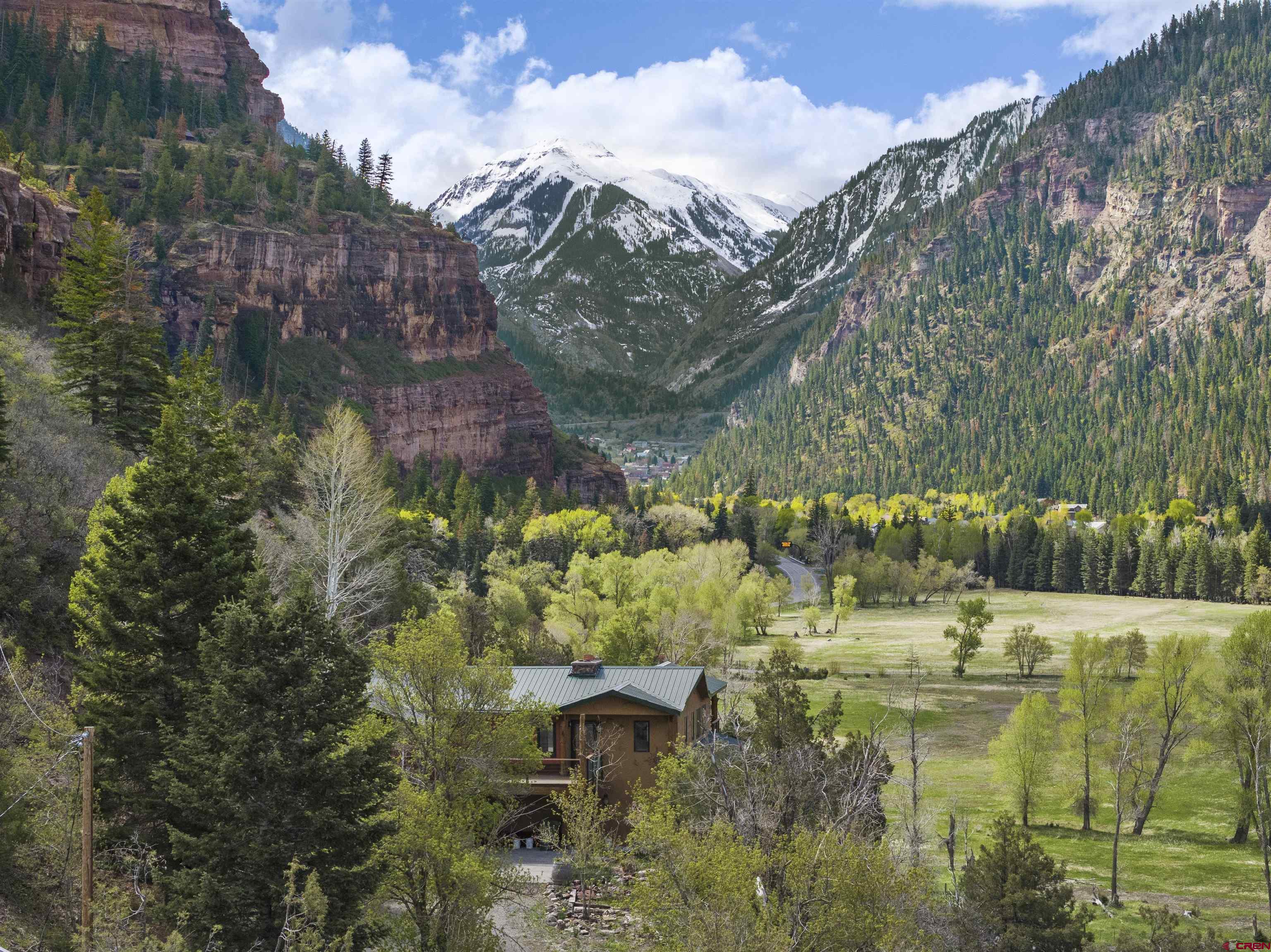 Stunning Mountain Retreat with Spectacular Views at 94 County Road 14, Ouray, CO 81427  Discover the perfect blend of rustic charm and modern sophistication in this beautifully renovated 3-bedroom, 4-bathroom mountain home, nestled on a 1.4-acre lot in the heart of Ouray, Colorado. This 2,407 sqft single-family residence, originally built in 1969, has been meticulously updated with high-end finishes and offers jaw-dropping views of Whitehouse, Wildhorse, and Courthouse mountains from every window. The property also borders National Forest with recreation just out your back door! No HOA or covenants allows you the freedom   Key Features: - **Prime Location**: Just minutes from historic downtown Ouray and Ridgway, with easy highway access for convenience and exploration. - **Luxurious Primary Suite**: Features a wall of windows with sweeping mountain views, a private kitchenette, a custom 5-piece bathroom, generous closet space, and a convenient laundry area. - **Gourmet Kitchen**: Equipped with top-of-the-line stainless steel appliances, granite countertops, and an open design that flows into a cozy living room with a wood-burning stove. - **Versatile Living Spaces**: Includes an office or dining area with stunning views, two upstairs ensuite bedrooms with full baths, and a private third bedroom (no closet) for added seclusion. - **Outdoor Oasis**: Enjoy multiple decks, including a rear balcony perfect for Ouray’s 4th of July fireworks, and a scenic trail leading to a peaceful sitting area to immerse in nature. - **Modern Upgrades**: Tasteful remodel with wood and tile throughout, glass shower enclosures, and thoughtfully designed spaces for comfort and style.  This exceptional property offers a rare opportunity to own a piece of Colorado’s mountain paradise, combining serene privacy with proximity to Ouray’s vibrant community, known as the “Switzerland of America.” Ideal for those seeking a luxurious retreat or a year-round residence, this home is a must-see for anyone dreaming of the ultimate mountain lifestyle.