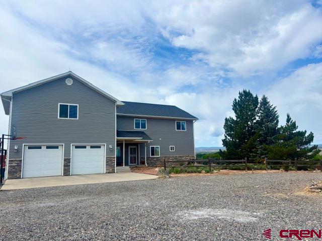 Exceptional Country Living on 44+ Acres – Modern Comfort Meets Rural Charm, beautiful views of the San Juans  Discover the perfect blend of space, comfort, and efficiency with this beautifully maintained 3,243 sq. ft. home, nestled on 44.41 acres of serene countryside. Built in 2003 and designed for both practicality and enjoyment, this property offers approximately 40 acres of irrigated land — ideal for hay production, hobby farming, or simply enjoying wide open spaces.  Step inside to an updated kitchen that flows seamlessly into inviting living areas.  The kitchen is complete with a custom wine/storage cabinet, in cabinet motion activated lighting, granite countertops, and more!  Picture yourself waking up every morning in the master bedroom with an incredible mountain view!  Upstairs holds two bedrooms, a flex room, a large bathroom complete with a laundry chute, and a spacious family/bonus room.  The bonus room can become the ultimate retreat with a mini refrigerator, pool table (included), and access to a private deck — perfect for relaxing or entertaining with scenic views.  This room is on its own heating and cooling system. This home also has a wine cellar and a central vacuum system.  On the property you will find a horseshoe area and a tree house for more entertainment!  Mountain views from almost every angle of this property!  Enjoy year-round comfort with energy-efficient geothermal heating and cooling, and take full advantage of the land with two frost-free water hydrants, an electric irrigation pump system with a gas pump as needed backup, and a productive grass hay field. The fully fenced property also features a small orchard, immaculately landscaped grounds, and a dog run with a shaded structure, making it both pet-friendly and purpose-built.  Relax and enjoy both inside and out.  Out front you will find a great view of the Grand Mesa as well as a spacious in-ground fire pit.  As a bonus, a designated wildlife corridor offers a rare opportunity to connect with nature in your own backyard.  This is more than a home — it’s a self-sufficient, turnkey lifestyle property ready for your next chapter. Whether you're seeking space to grow, ranch, entertain, or unwind, this property has it all!
