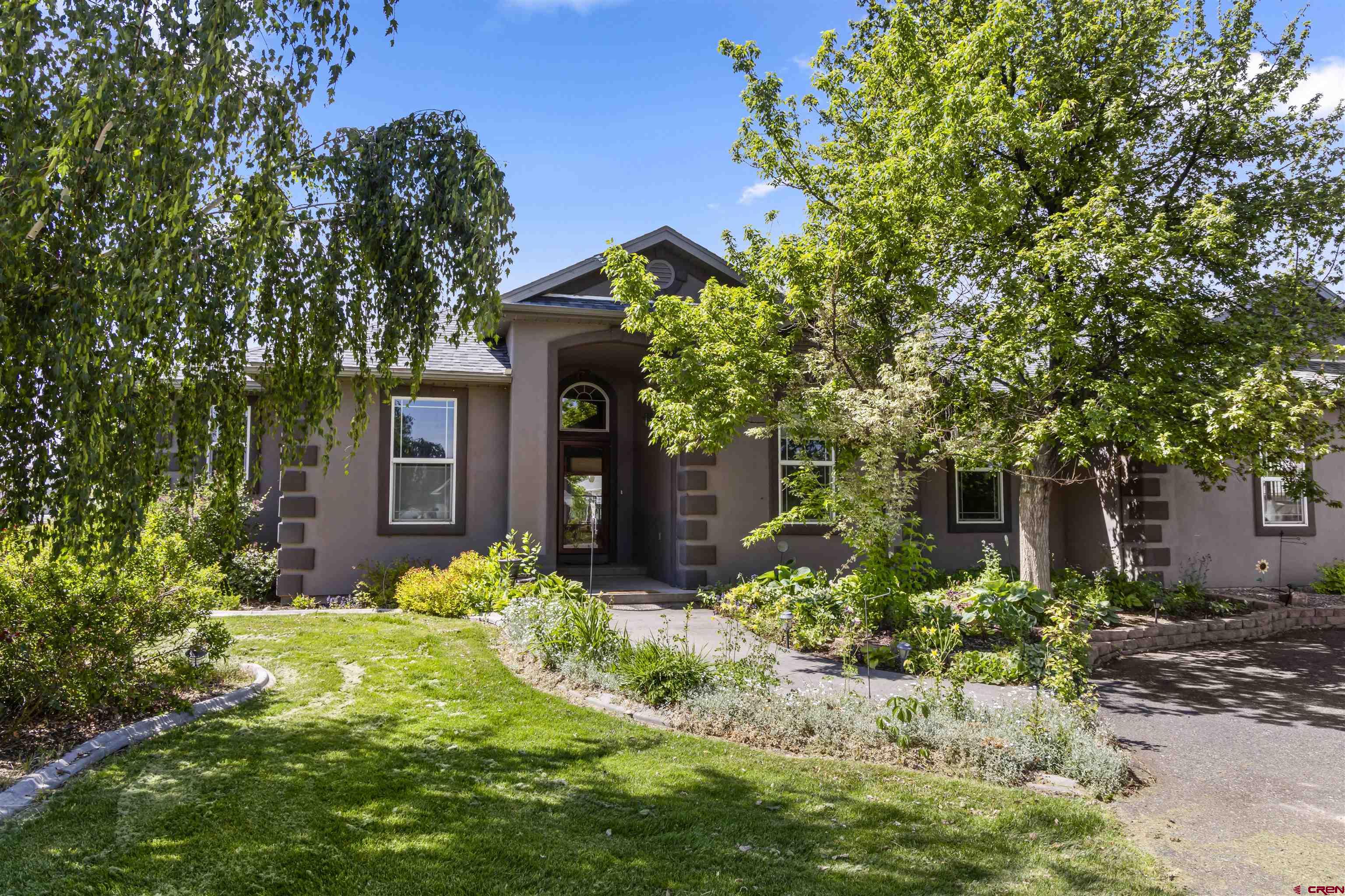 Well maintained 3 BR, 2-1/4 bath with office in a great neighborhood south of Montrose.   This home has 1+Acre of land with a beautifully landscaped yard with mature shrubs, trees and a lot of flowers.  Lush green yard from the sprinkler system which the water is furnished through the HOA.  The home has a split floor plan with Primary bedroom and bath that has jaguzzi tub and separate shower, double sink and large walk-in closet.  The large office with desk area and cabinets makes it easy to work from home.  Open floor plan with large living room dining/kitchen with brreakfast bar area. Nice gas fireplace in the living room.  In kitchen,  All Stainless appliances and a separate laundry room with 1/4 bath between Kitchen and garage.  There are washer/dryer hookups and a utility sink.  Washer/dryer not included.  Step out to you glorious back deck with a Pergola  The entire backyard is landscaped beautifully. Great deck/patio for you bbq  Enjoy a meal on the back deck or sit out to have your morning coffee while enjoying the Southern Mtn views.  The two car garage that is attached to the home also has a workshop pefect for numerous hobbies.  Outside you will find a 30 x 50 Heated detached shop with 12' overhead door plus attached storage rooms, 10 x 50 carport, RV parking, and a fenced in garden area with raised garden beds.  Plenty of storage outside of the shop.  The property has numerous possibilities in a beautiful setting.