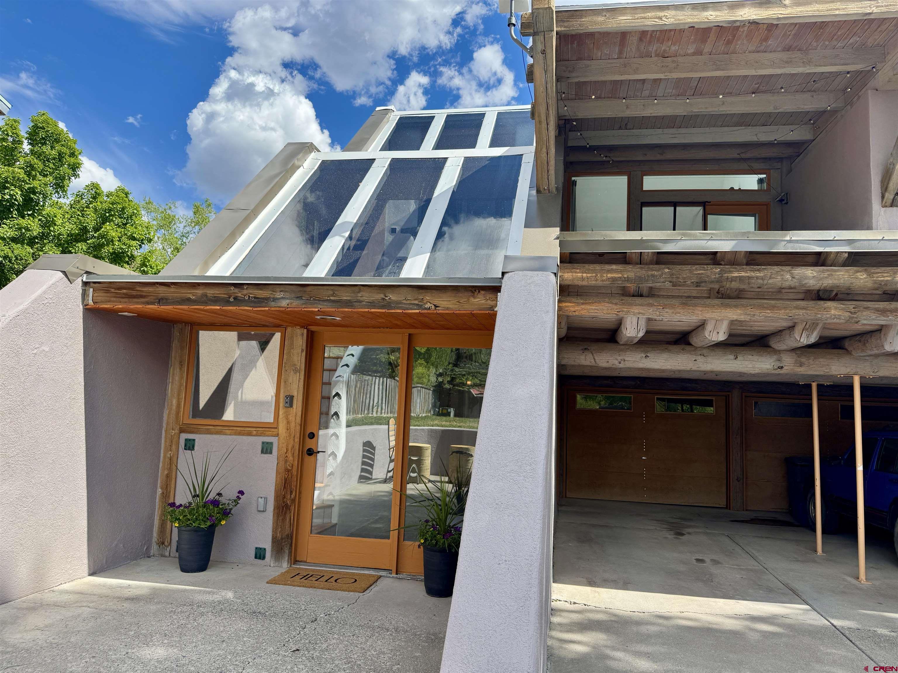 Adobe-Style Condo That Lives Like a Townhome – Light-Filled & Ideally Located Discover the perfect blend of Southwest charm and modern comfort in this neatly remodeled 2-bedroom, 1-bath condo that lives like a townhome. Ideally situated just blocks from downtown in Solar Ranches, this south-facing home is bathed in natural light thanks to large windows and a sunny atrium. Enjoy seamless indoor-outdoor living with a main floor patio, a second-story deck, and views of the Mount Sneffels range. The open, airy layout features in-floor radiant heat, an updated interior (2023), in-unit washer and dryer, and a private garage for convenience. Nestled between Solar Ranches open space and Cottonwood Creek Park, you'll have access to trails and mountain vistas right outside your door—yet still be minutes from charming downtown Ridgway. This unique condo offers low-maintenance living with the feel of a private townhome—bright, peaceful, and move-in ready.