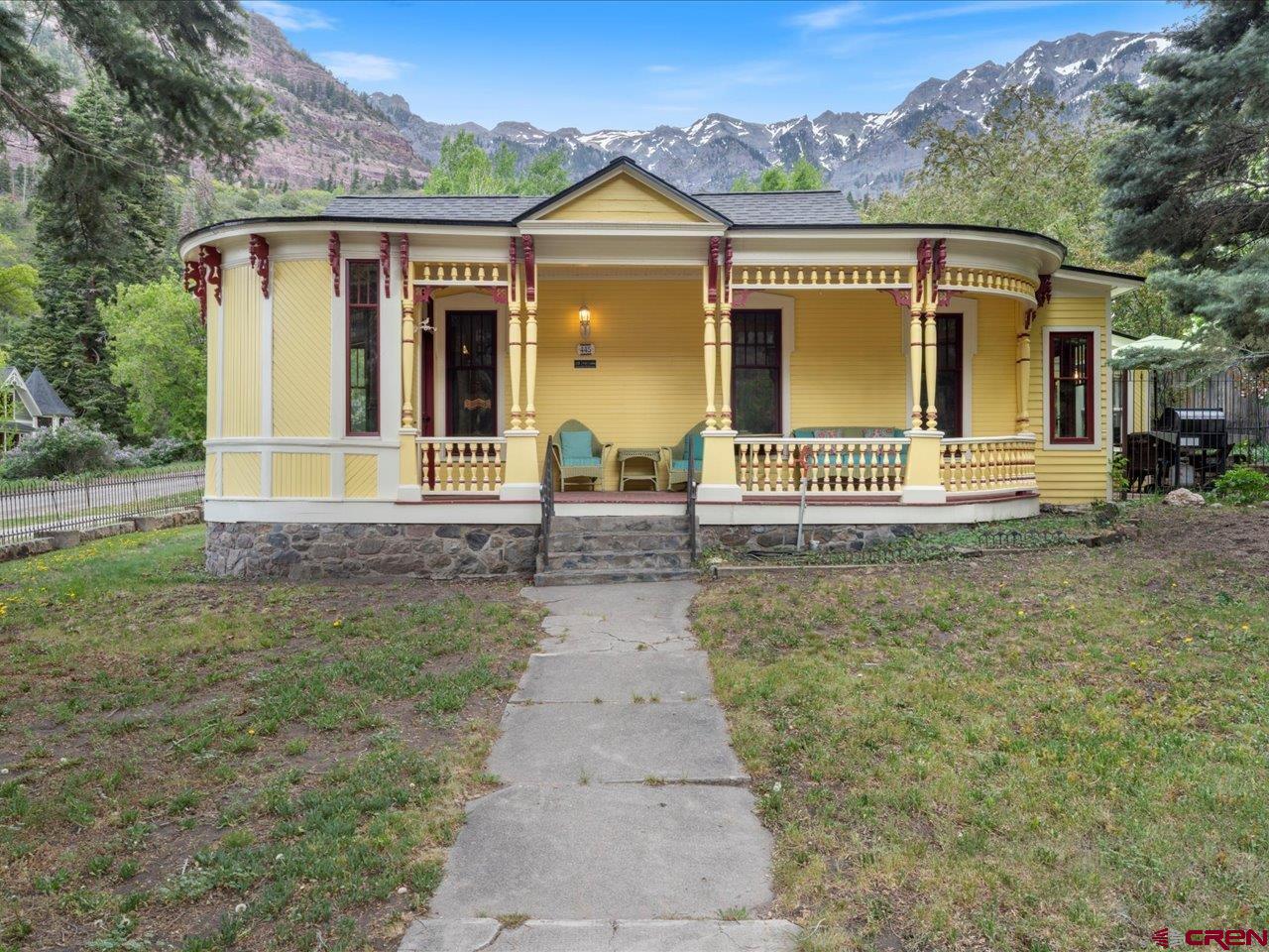 Step back a century in this charming 1885 vintage Victorian in the heart of Ouray.  This classic has all the awesome features you look for in a Victorian. Inlaid hardwood floors, classic windows and trim, clawfoot bathtub and pull chain toilet where the water is above your head, just to name a few. The sun room/breakfast nook is perfect for growing your own greens and flowers. The little carriage house that is used primarily for storage has been turned into a nice bunk room for the kids.  It doesn't have water or sewer but is a nice place for kids to play and sleep at night.  The primary bedroom has a modern bathroom with a shower and is located in the upper floor.  It has a balcony with views of the Amphitheater.  The front porch looks out at Twin Peaks and sister peak.  There are several large old pine trees in the yard that look a few hundred years old.  The house was completely redone in the period in which it was built.  There is so much character. Three years ago the owners installed new windows, two doors on the 1st level, replaced a wooden staircase with a metal one off the primary bedroom and had the entire exterior painted.  Come see how charming this home is and how it will fit your family!