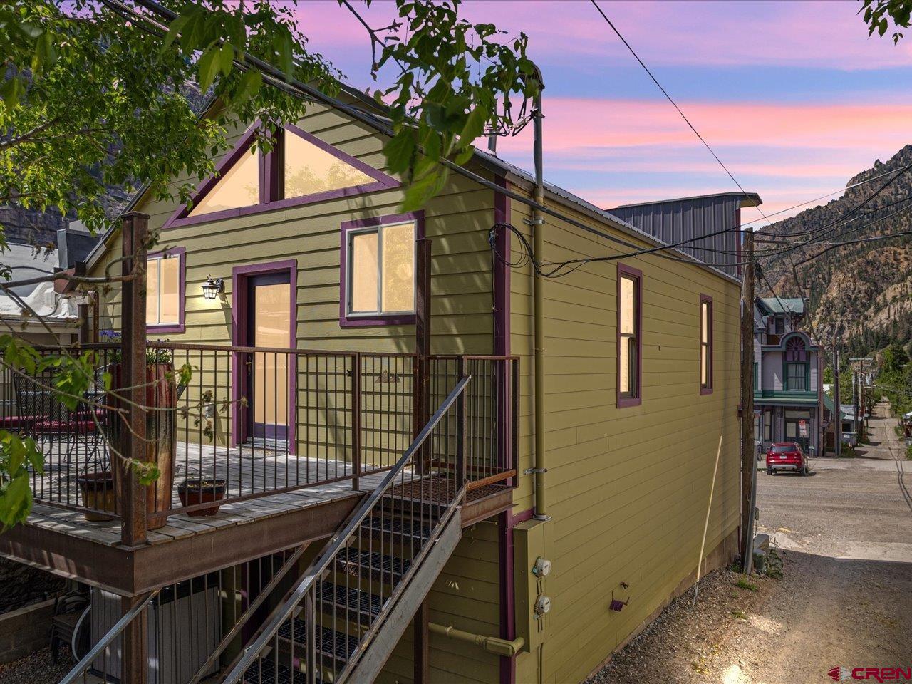This beautifully updated mixed-use property offers the perfect opportunity to live, work, and/or invest in one of Colorado’s most charming mountain towns. Just half a block from Main Street, directly across from city hall, this building features a fully remodeled second-floor one-bedroom, one-bath apartment and a stable, long-term commercial lease on the ground floor—providing immediate income and long-term flexibility. The entire upper level was taken down to the studs and completely remodeled in 2018 by renowned local builder Allison Construction, showcasing modern finishes and thoughtful design. The apartment features quartz countertops, hardwood floors, updated window treatments, and stylish furnishings—all included. The kitchen and bathroom were tastefully renovated as part of the full remodel and offer comfort and functionality in a bright, airy space. Step outside to a private south-facing deck with stunning views of the surrounding San Juan Mountains—your own peaceful retreat just steps from downtown. This apartment has operated successfully as an established licensed short-term vacation rental (over 175 reviews at 4.94/5) with strong occupancy and a loyal guest following, especially during the peak rental months of June through October. Whether you choose to continue operating it as a rental, live in it full-time, or use it as your own mountain getaway, it’s truly turn-key and ready to go. Downstairs, a well-established local bookkeeper and architect occupy the commercial space under a lease secured through April 2028, providing consistent, passive income. Don’t miss this rare opportunity to own a flexible, income-generating property in a prime location. Schedule your showing today and see the potential for yourself.