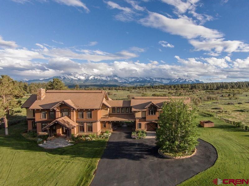 Welcome to the exquisite 41-acre R-Bar-D Ranch nestled in the breathtaking landscapes of Ouray County's San Juan Mountains. This one-of-a-kind property boasts a stunning main house spanning 7,603 square feet, complemented by a guest log cabin with 1,899 square feet of refined ruggedness. Blending the enduring charm of French Country architecture with the timeless allure of Colorado Mountain Style, this ranch is impeccably appointed for those who value both lasting elegance and unparalleled scenic vistas. As you approach the estate, the meticulous landscaping and attention to detail become evident, showcasing the seamless integration of the property with its natural surroundings.  No expense was spared in the construction of both the main and guest houses, resulting in a property that radiates luxury and craftsmanship. The main house welcomes you with grandeur, featuring spacious living areas, soaring ceilings, and exquisite finishes throughout. With 7,603 square feet of living space, this residence offers a perfect balance of opulence and comfort. The layout is designed to cater to a lifestyle centered around entertaining, with ample spaces for gatherings and events. The guest house is a perfect arrangement for visitors or multigenerational living. The 41 acres of land surrounding the property offer a wealth of outdoor opportunities. Whether you're a nature enthusiast, equestrian lover, or simply seeking a peaceful escape, the ranch provides a backdrop for an idyllic outdoor lifestyle. The vast grounds offer a mix of manicured lawns, picturesque gardens, and open spaces, providing an environment for relaxation and recreation. This ranch stands out as a truly exceptional find. The foresight and planning that went into securing this dual-residence sanctuary make it a rare gem that discerning buyers won't find elsewhere.