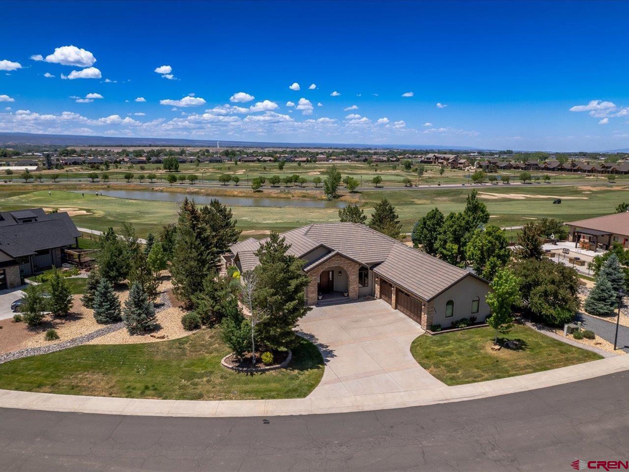 Welcome to a rare opportunity in The Bridges — Montrose’s premier golf course community. Perfectly situated on the 8th fairway with views of the green, this beautifully updated home offers over 3,100 square feet all on one level, surrounded by mature landscaping and quiet elegance.  Set on one of the largest lots in the Bridges, (two full lots put together). The outdoor space is a true retreat. Winding garden paths, towering pines, and a tranquil fountain create a peaceful backdrop for everyday living. The spacious covered rear patio with a pergola invites you to relax, entertain, and take in the pristine golf course setting. Inside, the home has been thoughtfully upgraded. A completely remodeled primary bathroom features spa-inspired finishes and in-floor heating for year-round comfort. Newer hardwood flooring adds warmth and character, while the freshly updated kitchen cabinets brighten the heart of the home. Newer fixtures and mechanical equipment are among the many details that reflect quality and care throughout, including a climate controlled garage.  This home feels like new — yet offers the rare benefit of an established, lush setting. Quiet, private, and move-in ready, it's a perfect blend of luxury and livability.  Whether you're drawn to the golf lifestyle or simply seeking peace and space in a refined setting, this home offers it all.  Come experience it for yourself. Schedule your private showing today and discover why 2671 Redcliff Circle is a standout in Montrose.  For The Bridges Golf and County Club Community information and membership requirements, please see Greg Bray (General Manager) at The Bridges Clubhouse to schedule an appointment for your personal tour.
