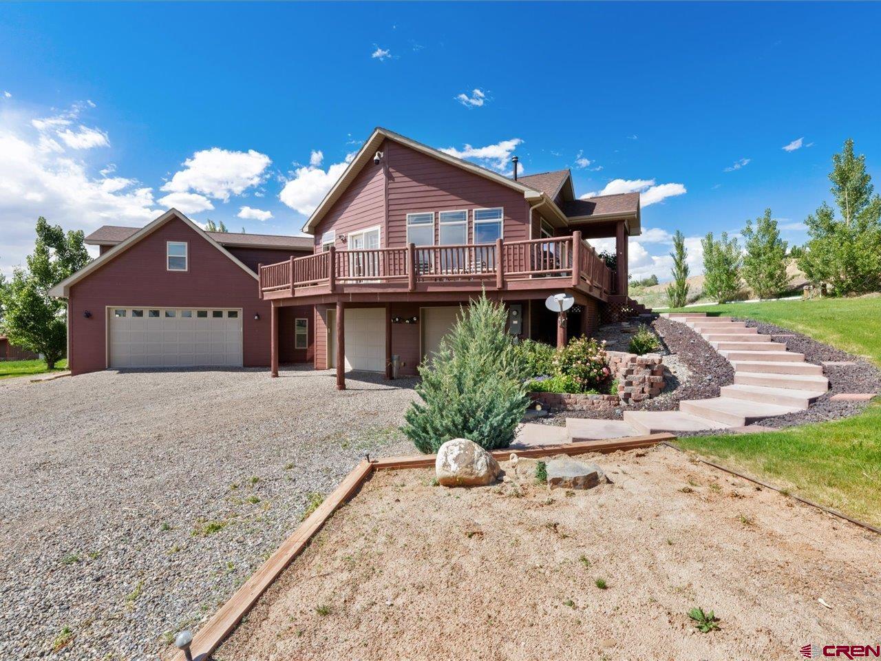 Picture yourself in this beautiful country 3554 square foot home with views, two large 30 x 40 shops and all on 6.894 acres with irrigation water. This home is a custom Kopper Creek home on a stick built foundation and add-ons. It features a gourmet kitchen w/ Corian countertops, Stainless Steel appliances, large center island w/ prep sink, slate floors, and the views from the kitchen sink are amazing. Remodeled in 2018, this beauty encompasses a large great room, 5 bedrooms, 3 bathrooms, and a 5 car garage. There is a whole house water filtration system also for piece of mind also. You can entertain out on the deck watching the beautiful sunsets with privacy and piece of mind with no covenants. The HOA is only for the irrigation water.  The primary suite feels so cozy with an electric fireplace, and the en-suite bathroom allows you to relax with a jetted tub, step-in shower, double sink vanity, plantation shutters, and a large walk-in closet. The main level also features 2 additional bedrooms, a full bath with skylight, large laundry room w/ sink and exit door to back yard and a 500 sq. ft. space off of the great room that is finished and can be a home office, play room or workout room. Down in the finished basement you'll find a family room, 2 bedrooms, a full bath and mud room coming in from the garage. For the enthusiast with tools, toys and cars there is a 5 car epoxy floored garage with additional space for storage or workbench. The icing on the cake is there are two large shops giving endless possibilities to suit your lifestyle.
