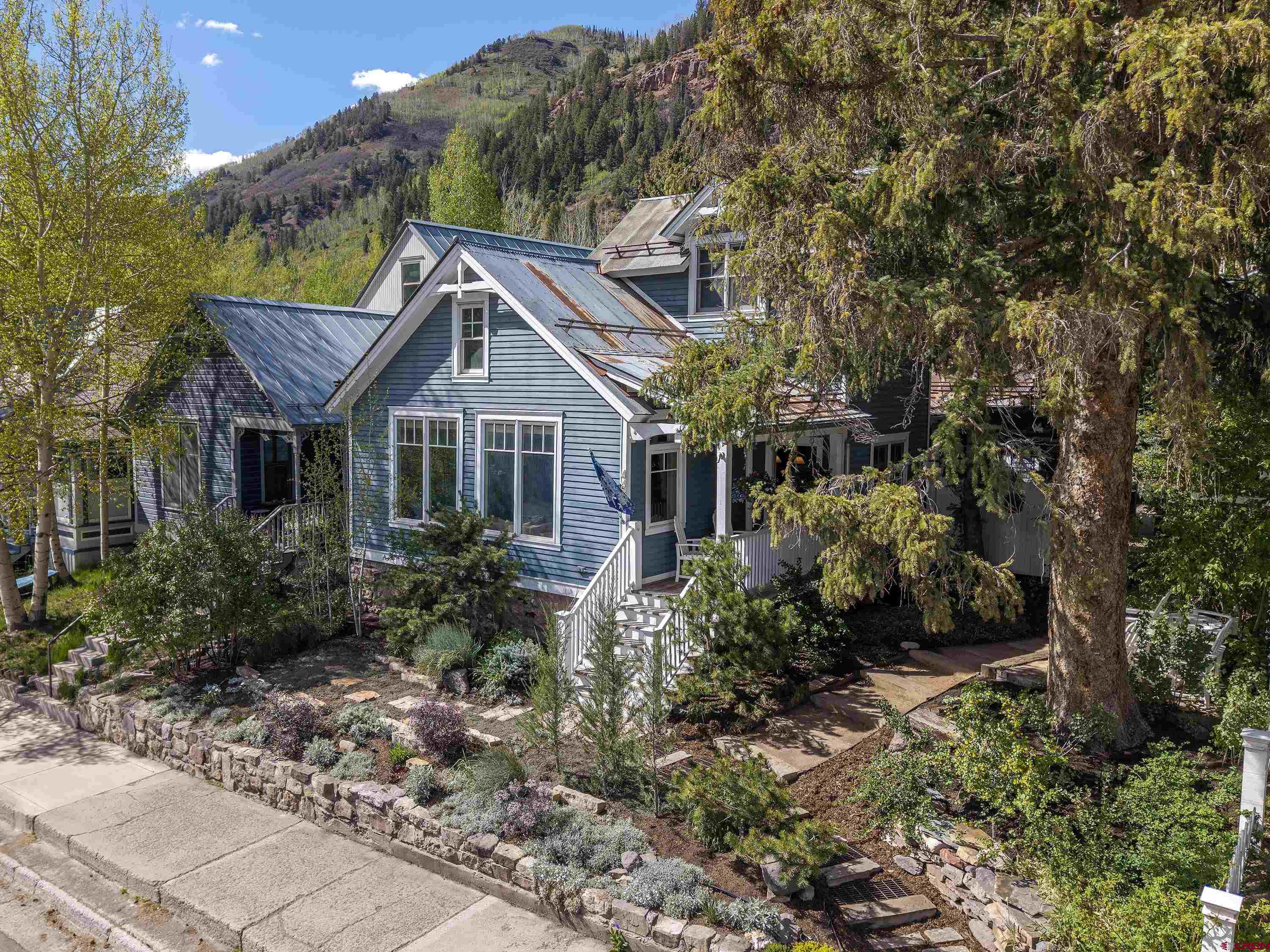 Historic Heart, Modern Soul—Just Steps from Telluride's Downtown Hub, 3 Blocks from the Gondola and Ski Lifts. The main residence sits on a rare double lot, blending historic character with a modern update. It features 3 bedrooms, 3 baths, and a flex room that can serve as a 4th bedroom. A character-filled caretaker's cabin is ideal for guests, home office, multigenerational living, or rental. The home's footprint may be expanded. Buyers may apply for a Telluride short-term business license. The house can be lifted, and a lower level can be added without HARC approval. Enjoy views of the ski area, valley, and red cliffs from multiple outdoor living areas. The gardens, on drip irrigation, are breathtaking. This is a rare chance to own a piece of Telluride history—and shape its future.