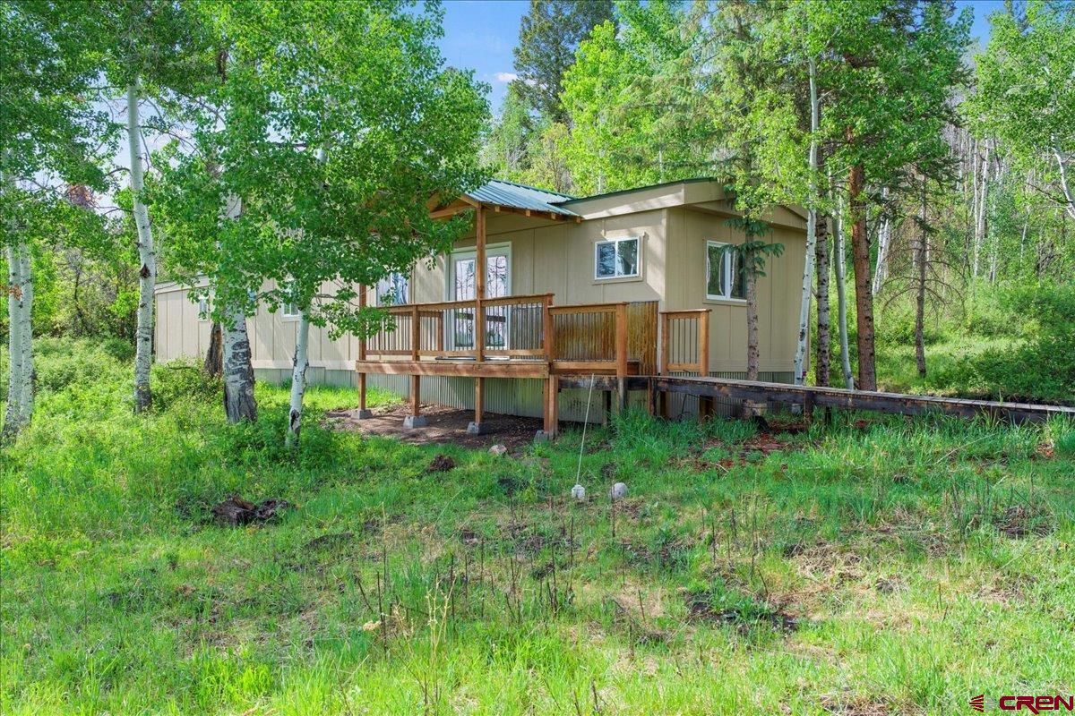 This beautiful property offers lovely views of snow-capped mountains and a peaceful green space filled with aspens, where deer and elk are often seen roaming. The charming mobile home has been recently remodeled with new flooring, cabinetry, countertops, and appliances. Both bathrooms have been updated, and the home features new plumbing, upgraded electrical, and a high-efficiency propane heater. The remodel also includes all-new windows, doors, and exterior siding. A covered front porch invites you to relax and take in the surrounding beauty or provides a sheltered entry during inclement weather. Located just 10 minutes from downtown Ridgway, this property would make a perfect summer escape from southern heat and humidity, a great hunting basecamp, or a sweet place to call home.