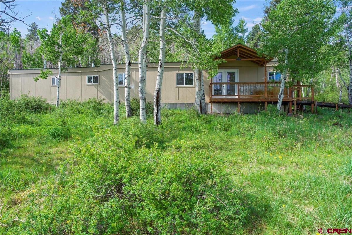 MOTIVATED SELLERS!!! This beautiful property offers lovely views of snow-capped mountains and a peaceful green space filled with aspens, where deer and elk are often seen roaming. The charming mobile home has been recently remodeled with new flooring, cabinetry, countertops, and appliances. Both bathrooms have been updated, and the home features new plumbing, upgraded electrical, and a high-efficiency propane heater. The remodel also includes all-new windows, doors, and exterior siding. A covered front porch invites you to relax and take in the surrounding beauty or provides a sheltered entry during inclement weather. Located just 10 minutes from downtown Ridgway, this property would make a perfect summer escape from southern heat and humidity, a great hunting basecamp, or a sweet place to call home.