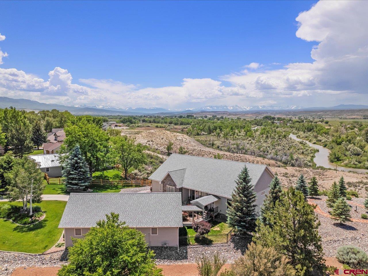 Colorado estate with majestic panoramic San Juan mountain and Uncompahgre river views. This custom home sits on a 1.11 irrigated acre escarpment protecting the home's views from any future obstructions. Mature landscaping on a drip system makes for a park like setting. The inside of the home is equally jaw dropping with a new open floor plan. As you enter you are greeted with a large formal dining room, living room area with fireplace, kitchen with granite countertops, stainless steel appliances (all included), and a desired amount of cabinet space. The breakfast nook is one highlight of this home with the amazing views through the windows, imagine sipping your coffee at the table or step outside to the large covered deck. Enjoy the large primary suite features a spa like bathroom and walk-in closet with a nearby library, office, or 4th bedroom, and full bath. Down the hall from the dining area is a large laundry room with included washer and dryer and sink with extra storage room. You will also be pleased to see two generous sized guest bedrooms, and full bathroom. All located on the main level. The basement keeps the momentum continuing with a large storage room, open living room, additional kitchenette perfect for multigenerational living. Step outside to the covered patio area here too to take in these views. The detached 3+ garage allows for extra space with work bench and epoxy floors. A property like this doesn't come along very often, don't let it get away. Close to mountain recreation like biking, skiing, hiking, and fly-fishing only a short drive from the property. Make your dreams come true and come see it today!