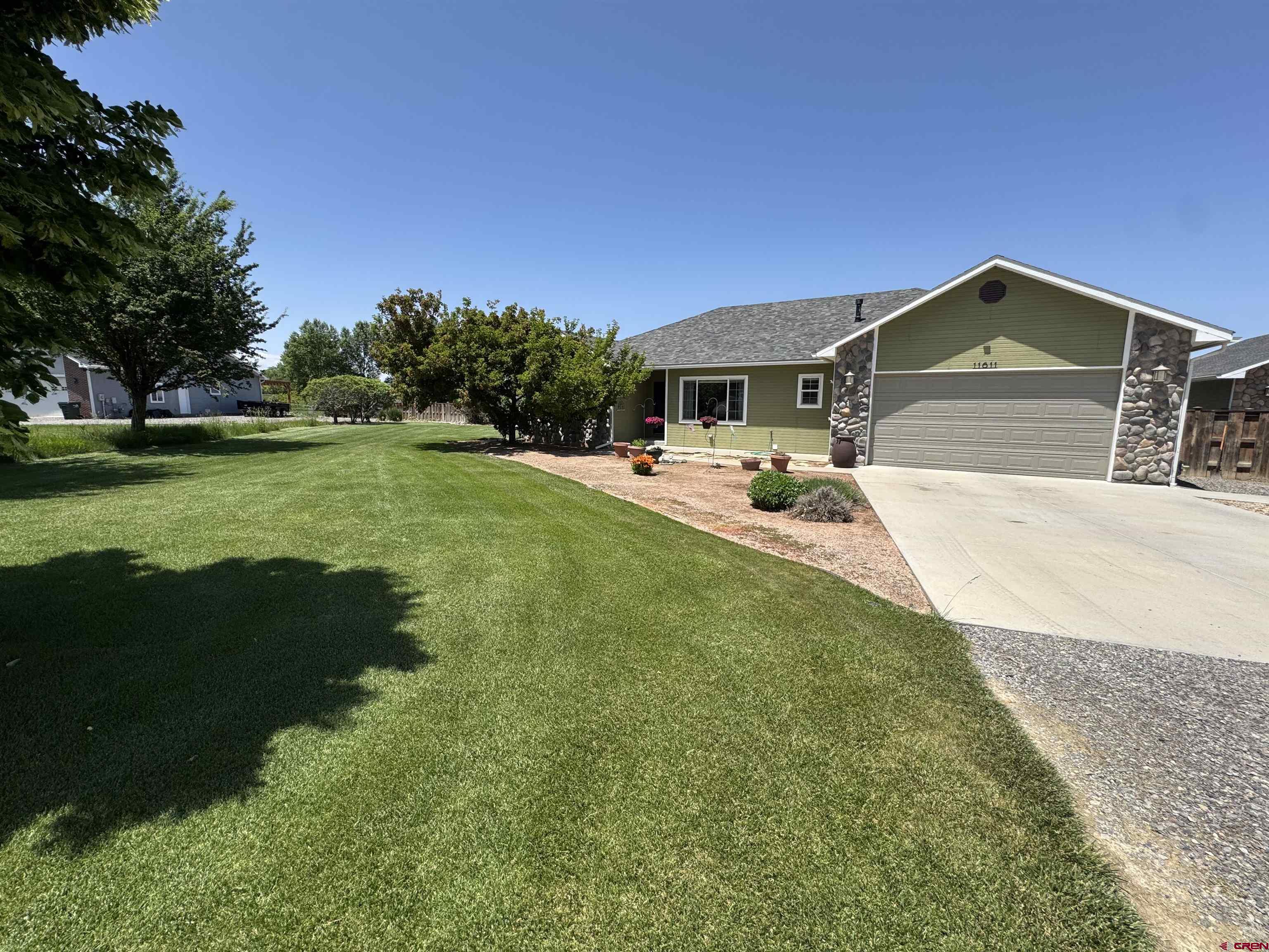 Welcome to your dream property in the heart of Montrose! Nestled on 1.3 beautifully landscaped acres in the sought-after Bountiful Acres subdivision, this immaculate home offers the perfect blend of comfort, space, and functionality. Built in 2002, this well-maintained home features an open floor plan with vaulted ceilings, creating a spacious and airy living environment. The recently updated kitchen is a true showstopper—modern finishes, ample counter space, and a smart layout make it the heart of the home. Enjoy cozy winters with efficient radiant in-floor heating throughout. The large master suite is a relaxing retreat, complete with a generous walk-in closet and a luxurious en-suite master bath. Two additional bedrooms and baths offer comfort and flexibility for guests, family, or home office use. Step outside to a huge, fully landscaped yard with mature trees and privacy—all overlooking open fields for that peaceful country feel. For hobbyists and professionals alike, the 24x36 insulated shop is a standout feature, and there's plenty of room for your toys or RV with dedicated RV parking. This property offers a rare combination of tranquility, space, and convenience, just minutes from town amenities.  Key Features:  1.3 Acres in Bountiful Acres Subdivision  Built in 2002 – meticulously maintained  24x36 insulated shop  RV parking  Vaulted ceilings & open floor plan  Radiant in-floor heating  Stunning updated kitchen  Large master suite with walk-in closet and en-suite bath  Expansive yard with mature landscaping  Serene views of open fields looking towards the Grand Mesa  Don’t miss your opportunity to own this beautiful slice of Montrose living. Schedule your private tour today!