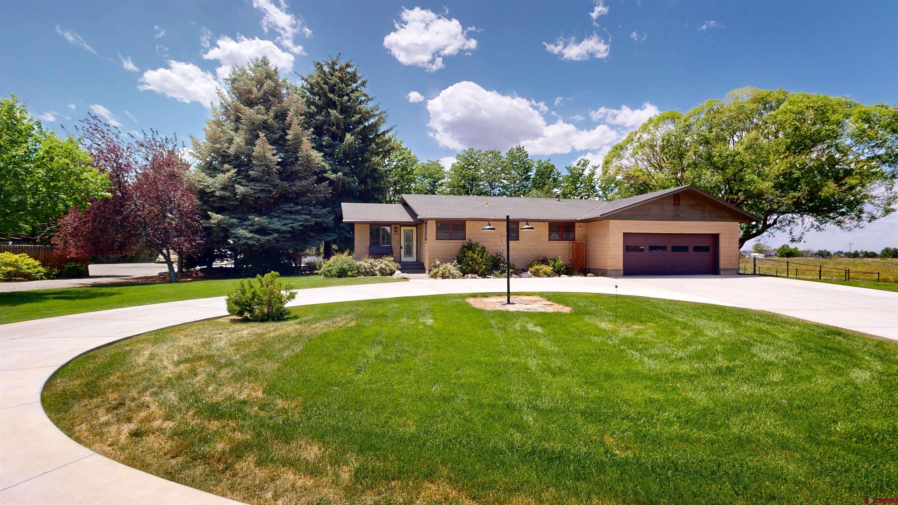 Charming 3-Bedroom Ranch Home with Workshop & Acreage   Welcome to your dream property nestled on 1.9 irrigated acres just minutes from downtown Montrose, Colorado, along scenic Highway 90. This spacious 2,560 sq ft ranch-style home offers 3 bedrooms, 3 bathrooms, and a full basement—providing plenty of room for living, entertaining, and storage.  Outside, the property truly shines with a 30 x 40 heated workshop complete with two oversized lean-tos and its own bathroom—ideal for hobbies, a home business, or serious projects. Additional outbuildings include a 30 x 40 hoop storage shed, a 20 x 40 RV port, and a 18 x 22 garden/storage shed with electricity, offering all the space and utility you need.  Relax on the deck or step into the beautifully landscaped backyard oasis, shaded by mature trees and perfect for relaxing evenings or summer gatherings. Whether you're a gardener, craftsman, or simply seeking space and tranquility close to town, this property has it all.  Don’t miss the opportunity to enjoy country living with city convenience—schedule your showing today!