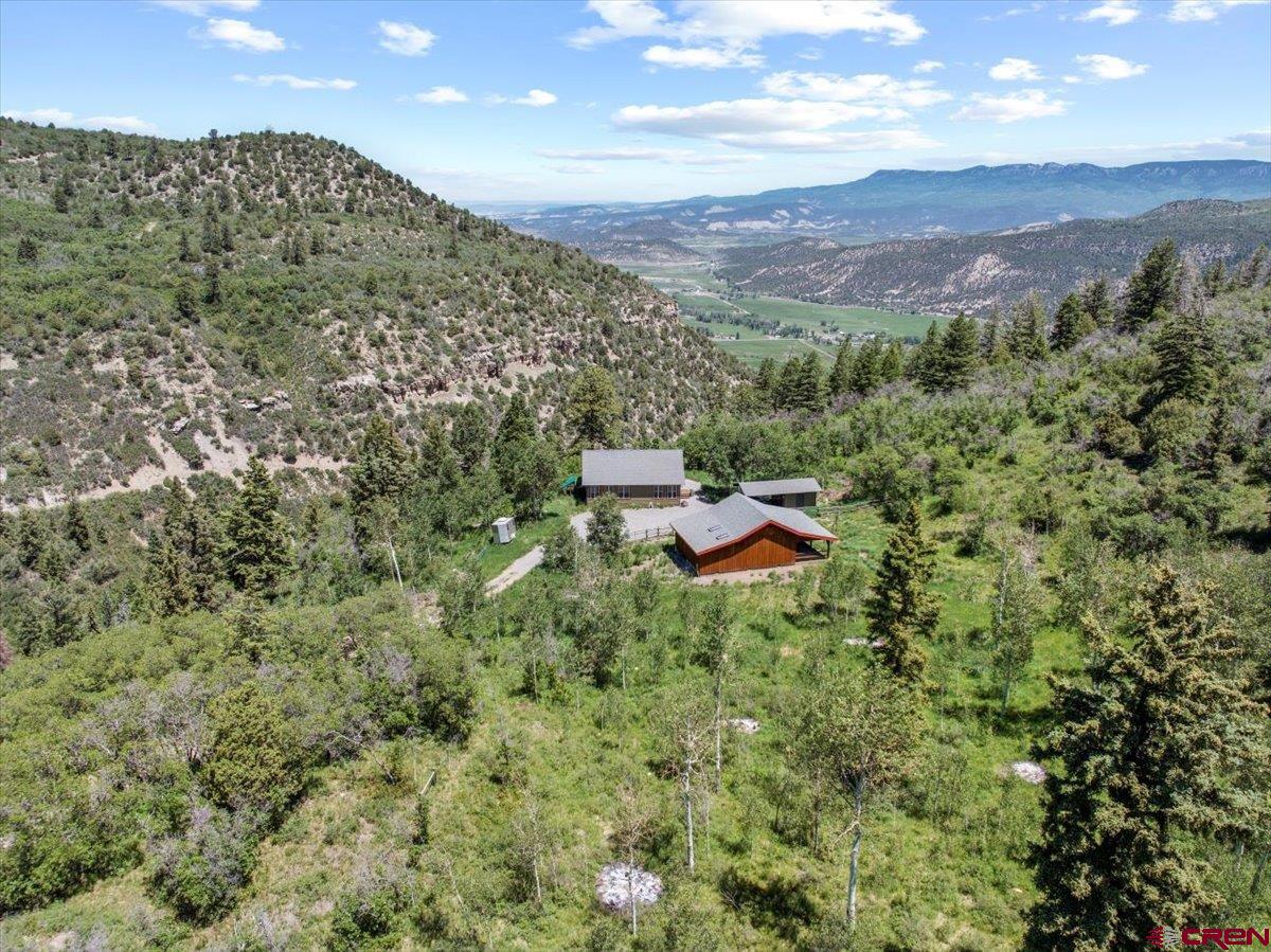 Park Estates has become one of the area's most prestigeous areas because of the high quality homes, excellent views, access into public lands, and year round access.  It's located on the western ridges overlooking the Ridgway and Ouray Valley.  And its private gated access makes sure that the community's roads remain in great shape.  For those of you looking for a horse friendly retreat, you simply couldn't do any better and the trails and public lands of Park Estates will become your playground.  The main home is beautiful and carefully crafted to serve as a perfect year round permanent residence or seasonal escape.  It was built for the owners by favorite Ouray County Builder Allison construction to be easy to maintain and comfortable.  There are 1200 square feet, with a nicely sized great room that has wonderful mountain and valley views.  You'll love the white oak floors, vaulted pine tongue and groove ceilings, quality wood stove set in its northeast corner.  Sliders allow you to walk out to another 480 square feet of covered outside living space that overlooks the town of Ridgway and allows you to peer down toward Coal Creek with is located on the lower portions of the property.  The kitchen and dining room areas are on the west side of the home, with a well appointed kitchen that boasts quality appliances.  Of special significance is two side by side refrigerator freezers-a nice idea to be sure you're properly prepared for visitors.  Both bedrooms are quite nice-the primary has a large bath with soaking tub and shower that looks south to the mountains.  The second bedroom, which is perfect for an office, workout room or studio too, is situated in the southeast corner, and the second bath is located nearby, off of the great room, for the convenience of not just your family but also your guests.  Dependable utilities are important in the mountains, and the state of the art water system is dialed in to provide excellent water through the Park Estates water system.  The water, along with the road maintenance are included in the low annual dues.  The horse barn created on the property is a horse person's dream.  It was designed by the owner and constructed by Allison construction.  it incorportates the best of designs for this area,  including a long wall along its south side to protect from storms, a high vaulted roof with three stalls that have concrete floor set up on wood slats that lead out to a large open covered area. The property has been carefully fenced for the maintenance of horses and beauty. The rides  you'll take out to your personal trails as well as from this property into the National Forest will be a unique delight for you, your family and friends.  Thousand of acres of public land await your adventures.  Near the barn is a storage building, ready for the storage of your toys, and set up to be a carport for cars or your ATV.  it's situated perfectly beteen the home and barn.  What's your Colorado dream?  Is it land where you can enjoy it now with the plan to expand someday?  Maybe it's your year round home privately locacate away from the towns and surrounded by deer and elk and other wildlife?  Perhaps its a weekend  or summer home, away from heat and humidity?  No matter what your vision, this quality home on 39 acres in Park Estates has all you need!