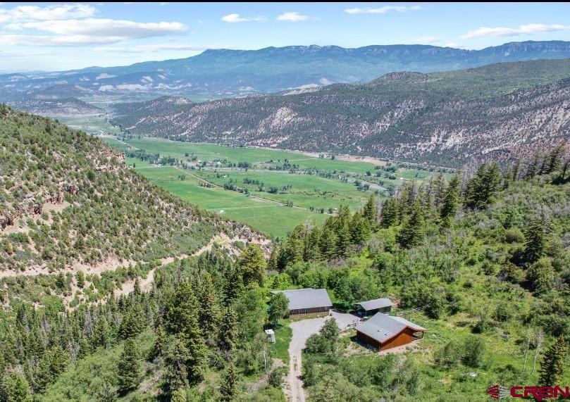 Park Estates has become one of the area's most prestigeous areas because of the high quality homes, excellent views, access into public lands, and year round access.  It's located on the western ridges overlooking the Ridgway and Ouray Valley.  And its private gated access makes sure that the community's roads remain in great shape.  For those of you looking for a horse friendly retreat, you simply couldn't do any better and the trails and public lands of Park Estates will become your playground.  The main home is beautiful and carefully crafted to serve as a perfect year round permanent residence or seasonal escape.  It was built for the owners by favorite Ouray County Builder Allison construction to be easy to maintain and comfortable.  There are 1200 square feet, with a nicely sized great room that has wonderful mountain and valley views.  You'll love the white oak floors, vaulted pine tongue and groove ceilings, quality wood stove set in its northeast corner.  Sliders allow you to walk out to another 480 square feet of covered outside living space that overlooks the town of Ridgway and allows you to peer down toward Coal Creek with is located on the lower portions of the property.  The kitchen and dining room areas are on the west side of the home, with a well appointed kitchen that boasts quality appliances.  Of special significance is two side by side refrigerator freezers-a nice idea to be sure you're properly prepared for visitors.  Both bedrooms are quite nice-the primary has a large bath with soaking tub and shower that looks south to the mountains.  The second bedroom, which is perfect for an office, workout room or studio too, is situated in the southeast corner, and the second bath is located nearby, off of the great room, for the convenience of not just your family but also your guests.  Dependable utilities are important in the mountains, and the state of the art water system is dialed in to provide excellent water through the Park Estates water system.  The water, along with the road maintenance are included in the low annual dues.  The horse barn created on the property is a horse person's dream.  It was designed by the owner and constructed by Allison construction.  it incorportates the best of designs for this area,  including a long wall along its south side to protect from storms, a high vaulted roof with three stalls that have concrete floor set up on wood slats that lead out to a large open covered area. The property has been carefully fenced for the maintenance of horses and beauty. The rides  you'll take out to your personal trails as well as from this property into the National Forest will be a unique delight for you, your family and friends.  Thousand of acres of public land await your adventures.  Near the barn is a storage building, ready for the storage of your toys, and set up to be a carport for cars or your ATV.  it's situated perfectly beteen the home and barn.  What's your Colorado dream?  Is it land where you can enjoy it now with the plan to expand someday?  Maybe it's your year round home privately locacate away from the towns and surrounded by deer and elk and other wildlife?  Perhaps its a weekend  or summer home, away from heat and humidity?  No matter what your vision, this quality home on 39 acres in Park Estates has all you need!