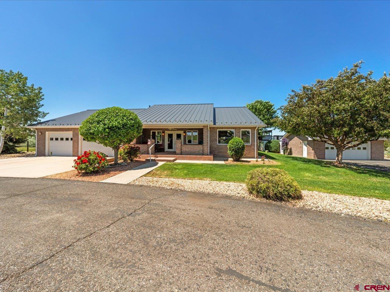 This well- built all brick ranch-style home sits on 11.525 irrigated acres with a serene pond offering a peaceful country lifestyle. The property features two domestic water taps, a three-car attached garage and an oversize two-car detached garage, providing ample space for vehicles and storage. A pole barn adds functionality for horse lovers or additional equipment.  Inside, the home includes three spacious bedrooms plus a dedicated office, perfect for working from home or extra living space.  Thoughtfully designed and solidly constructed, this home blends comfort, functionality, and rural charm, making it an ideal retreat for those seeking space, versatility, and timeless equality. Relax and enjoy the sun rise or the sun set on the beautiful private front porch