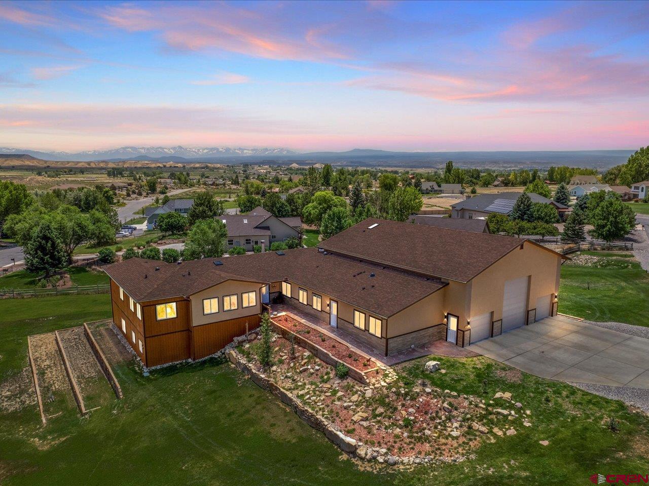 Luxurious Ranch-Style Retreat with Mountain Views – Western Slope, Colorado Welcome to your custom-built 2021 ranch-style retreat, nestled on 1.5 acres with breathtaking mountain views and just minutes from the Black Canyon of the Gunnison and Uncompahgre River. This spacious 7-bedroom, 5.5-bath home offers over 7,200 sq. ft. of elegant, energy-efficient living space — thoughtfully designed for comfort, accessibility, and entertaining. Enjoy an open-concept layout with a see-through rock-faced gas fireplace, sunroom with two indoor water features, and CoreLuxe plank flooring throughout. The gourmet kitchen features hickory cabinets, stainless appliances, a large island, and an oversized pantry. The fully finished walkout basement with 10-ft ceilings includes two bedrooms, a full kitchen, large living and flex/media rooms, 1.5 baths, and a massive workshop. A separate Au Pair/Mother-in-Law suite offers a private entrance, kitchen, bedroom, living area, laundry, and ¾ bath. Outdoor living is unmatched with a large Trex deck, built-in gas firepit, pond, waterfall, stream, and rock landscaping. The oversized 6-car garage includes a 43-ft RV bay with hookups. Energy-efficient features include R-71 ICF walls, R-59 ceilings, a geothermal system, and reverse osmosis water. Located just 6 miles from Montrose Regional Airport and near the future Montrose Regional Health Ambulatory Care Center. Experience comfort, luxury, and Colorado adventure—schedule your private showing today!