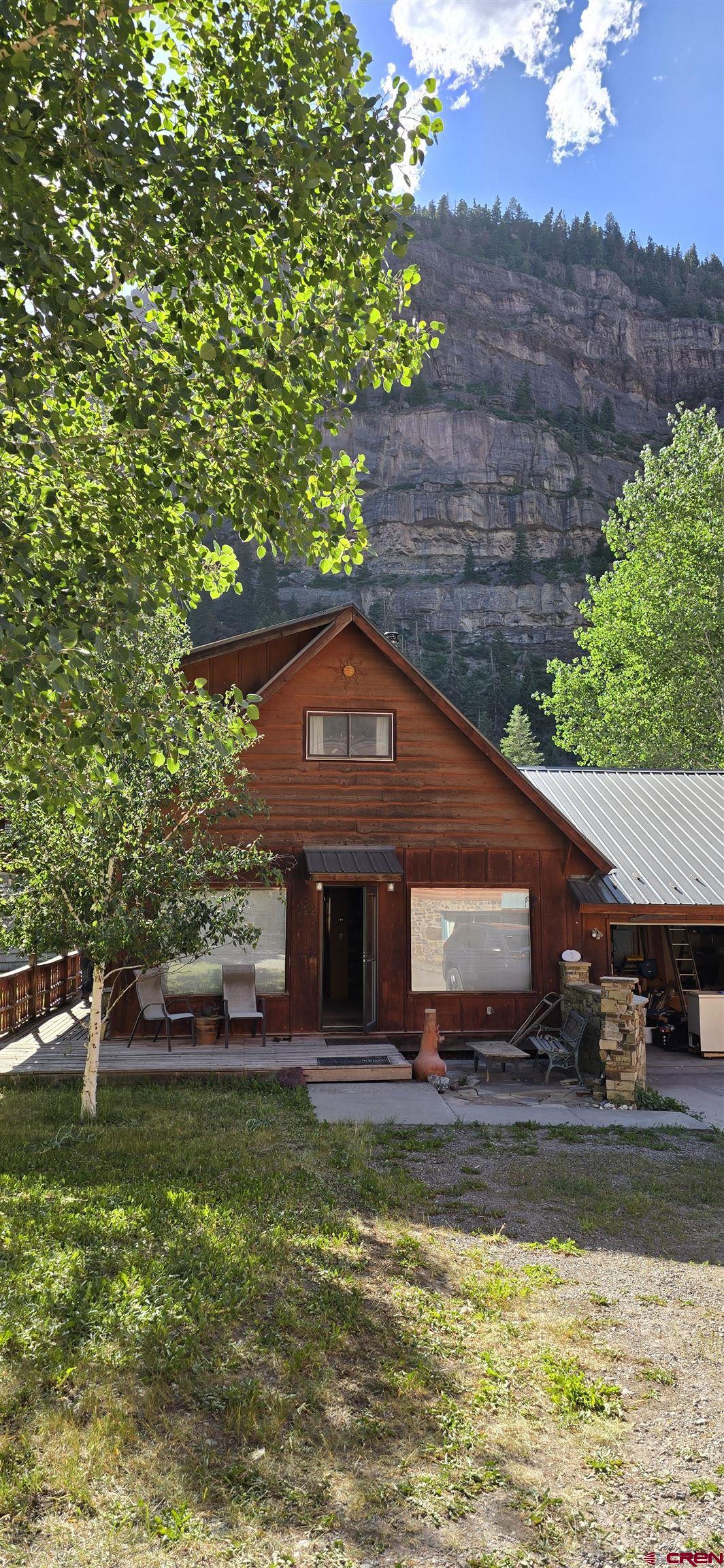 Charming 2 bedroom house in the heart of Ouray Colorado.  A little TLC will make this solid house a great home.  Large 2 car garage with a sunny yard.  Lots of storage, parking,  and room for your toys. R2 zoning allow for short term rentals.  Walk to everything Ouray has to offer.