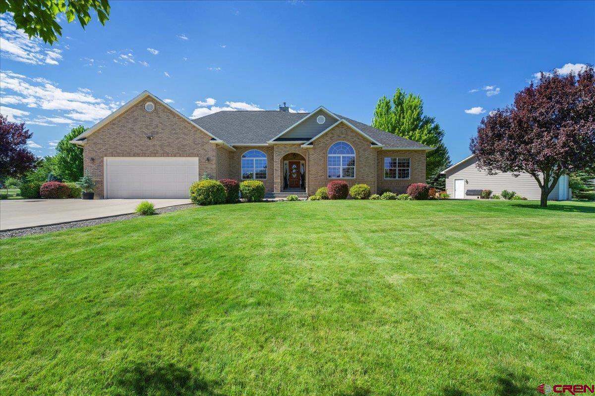 Welcome to this spacious 4-bedroom, 2.75-bath home with 4,068 sq.ft. of living space that sits on 1.13-acre premium corner lot that is beautifully landscaped and is in close proximity to the exclusive approx. 10+ acres of HOA river access. The home is accompanied by a 26' x 26' detached shop with a wood stove for year-round use. The main 3 car garage has one side that is 50' long and 25' on the other allowing for additional vehicles or storage. The main level offers 2,084 sq.ft. with large windows that bring in natural light and views to your backyard. The living room has a wood-burning fireplace and French doors leading to a patio with beautiful views of Buckhorn, hot tub area and fountain on the porch.   The remodeled kitchen features oak cabinets, quartz countertops, new stainless-steel appliances, a coffee bar, and a double oven. The dining area is a great place to entertain and to enjoy your morning and evening views. The primary suite has two walk-in closets, an attached bathroom with a jetted tub, separate shower, and two sink areas. In the laundry room has access to the garage and you will find a newer washer and dryer as well as sink for easy cleanup! The basement area (1,984 sq.ft.) is where you’ll find another wood-burning fireplace, a workout space, a TV/theater room, a 3/4 bathroom, and even room for two single beds—ideal for guests. There is a radon mitigation system in place as well. The home has many different storage areas for your convenience an in addition to the two fireplaces the home has as two furnaces as well. The yard is large and open with many mature trees, a hot tub, firepit area, and an in-ground trampoline. The yard and plenty of space to enjoy outdoor living and the long summer nights. This property is located South of Montrose and is a great location to get to outdoor recreation such as skiing, hiking and camping. Don't miss out on this property, with a motivated Seller it won't last long!