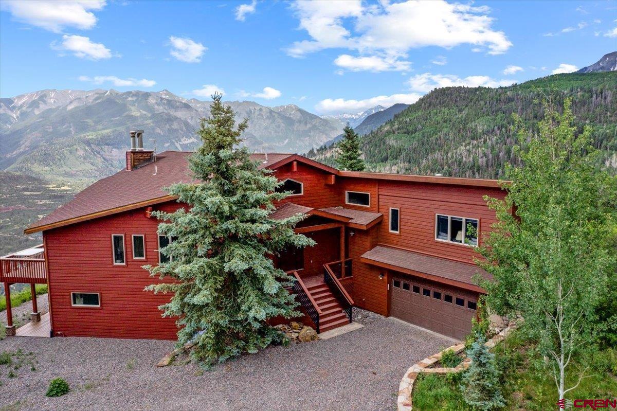 This is an offering that is unique and majestic, and offers the possibility of a year-round multigenerational escape.  There are two completely separate properties here, sold as one parcel, creating a mountain home of 70 acres, set midway between the iconic towns of Ridgway and Ouray, and within an easy drive of Telluride, Silverton and Montrose.  The west parcel has an incredible perch overlooking the Sneffels Range mountains and down Valley toward Mt. Abram south of Ouray.  This majestic home was completely redone this spring, with all new flooring, paint, kitchen counters and appliances.  The layout is ideal for large groups and intergenerational setups, with the primary suite on its main level, along with impressive great room offering some of the world's finest views right from the living areas.  In addition to the 4600 square feet of indoor space there's another 2000 square feet of beautifully maintained patios and decks to take in the big views.  This sits on a prime 35 acre Ouray County lot that is on the south end of Park Estates, so its private access into the National Forest is just a short hike away.  Year round road access provided by the Park Estates HOA allows you to use the property year round or seasonally-whatever fits your needs best.  The second parcel included with this sale aligns with the west edge of the main home property, with Golden Ridge Road providing most of its border.  It has multiple prime building sites, including an impressive point hanging out over the valley, which would make a tremendous perch for your new home.  The property has both Sneffels Range and Valley views, and offers the best sledding hills anywhere!  Its southwest portion is a beautiful pastoral valley, established with a 3 stall Morton barn and tack room.  The building can be used multiple ways, but former owners used it during the summers and falls to ride in the Park Estates area, but also into the thousand of acres of Public land.  While being sold together with the main home property in this listing, it is also available individually should you so choose.  Because it's a totally separate property some day you could sell it off or develop it separately with a friend or family member.   This is a unique opportunity to own something very special right in the heart of the Southwest Colorado area.  Make your plans to come see it today.