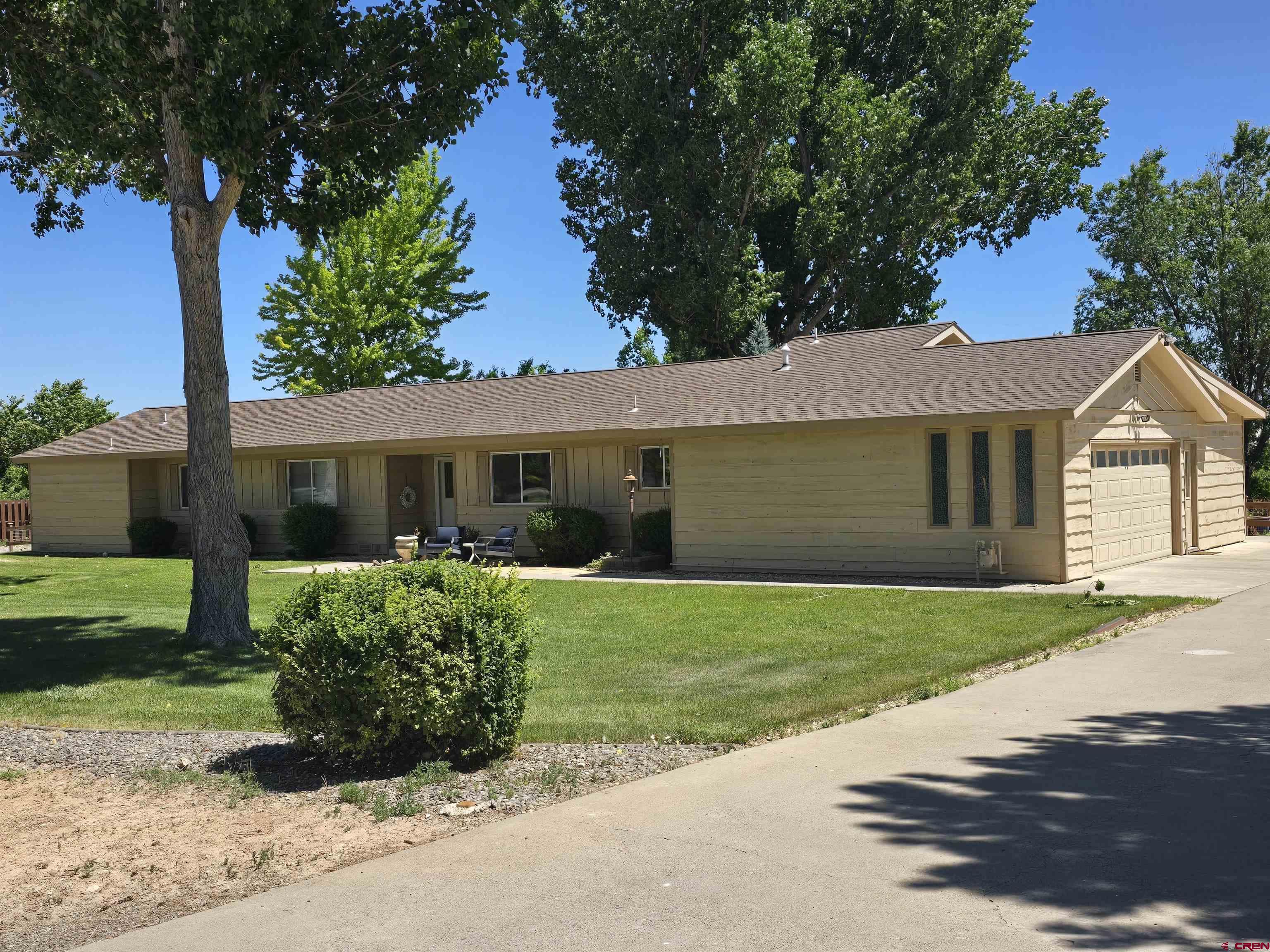 Stunningly remodeled home in sought after LeatherRidge subdivision sitting on 2.3 pristine acres, surrounded by serene ponds and breathtaking views. The home has been thoughtfully updated with modern finishes throughout. You are greeted with a big front yard and flag stone patio. Enter through a welcoming tiled entryway to this spacious, 2915 square foot, 3 bedroom/3 bath home and enjoy an inviting open floor plan that flows effortlessly between living, dining, kitchen, sunroom, and entertaining spaces. The heart of the home is the upgraded kitchen complete with custom walnut center island, ample cabinetry, double-drawer dishwasher, tiled floor, and amazing over-sized walk-in pantry accented by charming sliding barn doors. Enjoy two separate living areas, each with it's own fireplace, providing warmth and ambiance throughout the seasons. The huge tile-floored sunroom has abundant light from big windows looking into the backyard and beyond. The primary bedroom includes two closets, one linen closet, separate vanities, and full bath. Both guest bedrooms offers generous space and are served by a full hallway bath. The dedicated laundry room includes a convenient quarter bath and leads to a nice sized office space. The 2 car attached garage is seal coated. This property also has a 2 car, extra deep, detached garage, ideal for hobbies, work, or extra storage. Down the drive, there is also an over-sized 1 bay garage/shop with RV parking. The septic system was replaced 3 years ago. Walk out back to a relaxing, pergola-covered patio overlooking natural pastures, abundance of wildlife and water fowl, ponds, and great sun rises and sun sets. The backyard is fully fenced for your furry friends. The rest of the property is is also fenced for horses.  Don't wait, this rare opportunity could be Your Dream Come True. Schedule a tour today.