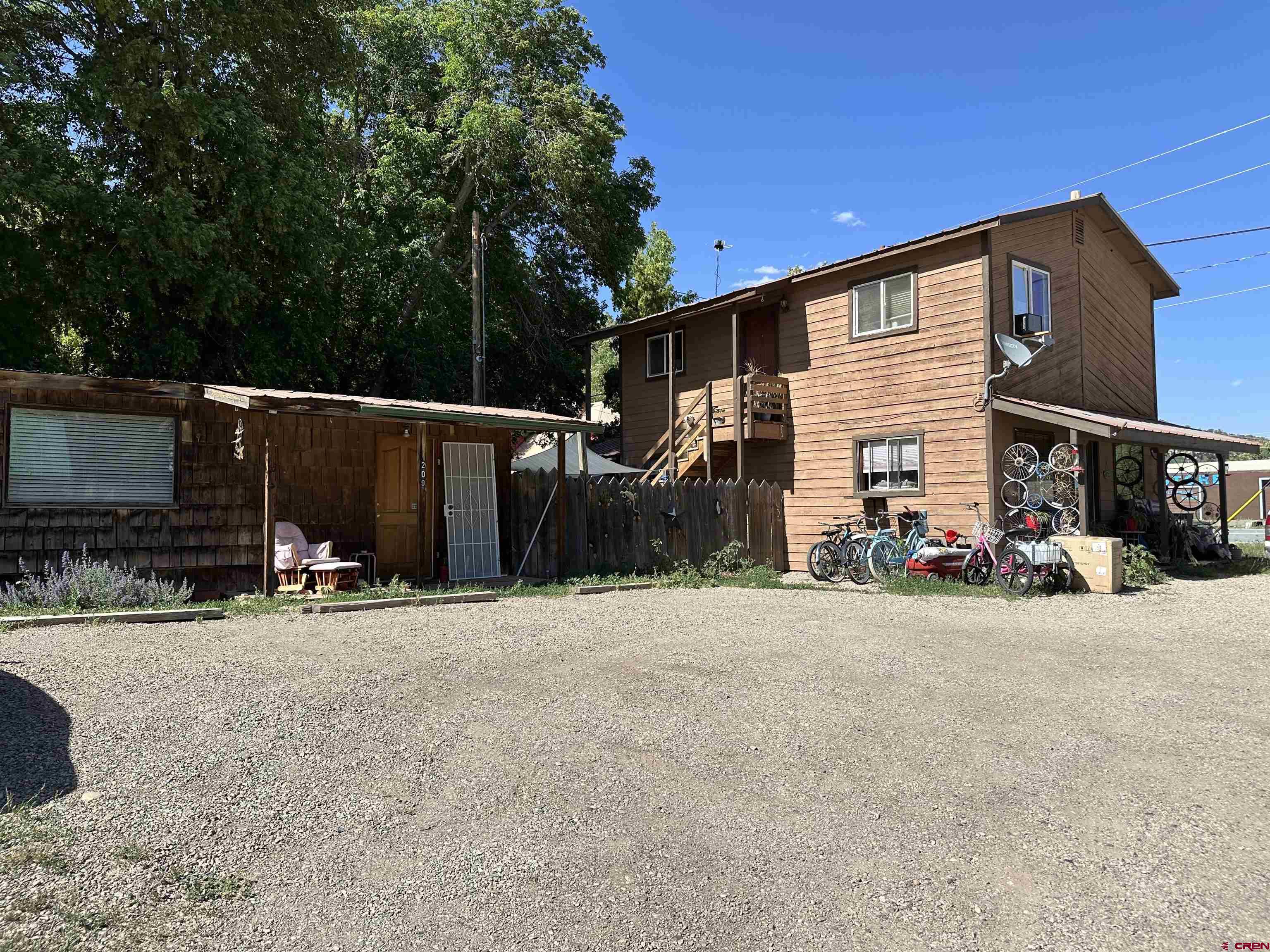INVESTMENT OPPORTUNITY!  Not many highway frontage properties come up for sale in the desirable town of Dolores.  There is a single residential one bed one bath home and a two-story duplex.  The lower unit is a one bed one bath and the upstairs unit is a two bed one bath.  All units have had consistent rental income for the past decade.  There is a great fenced outdoor entertaining area, mature trees, and convenient off-street parking.  Located within walking distance to restaurants, shopping, park and river access.  Call for a showing today!